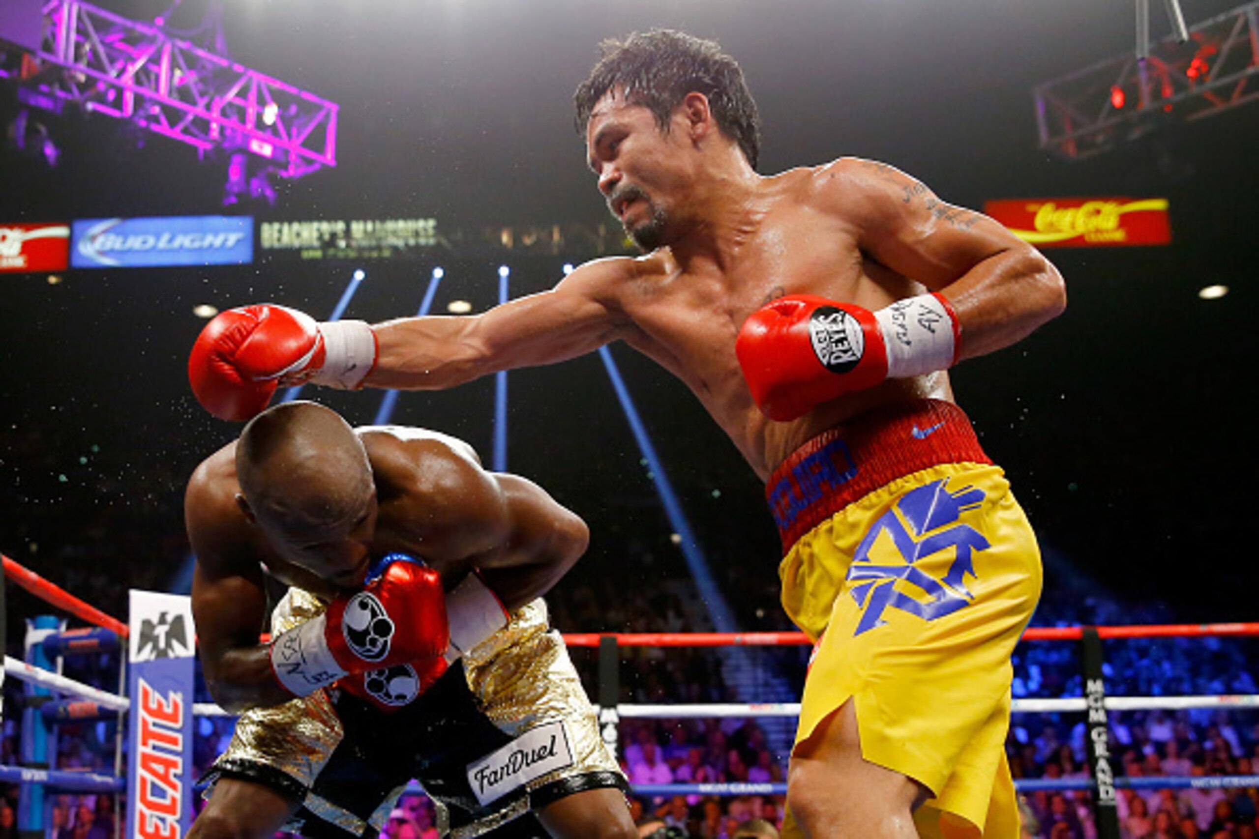 LAS VEGAS, NV - MAY 02: Floyd Mayweather Jr. ducks as Manny Pacquiao throws a right during their welterweight unification championship bout on May 2, 2015 at MGM Grand Garden Arena in Las Vegas, Nevada. (Photo by Al Bello/Getty Images) LAS VEGAS, NV - MAY 02: Floyd Mayweather Jr. ducks as Manny Pacquiao throws a right during their welterweight unification championship bout on May 2, 2015 at MGM Grand Garden Arena in Las Vegas, Nevada. (Photo by Al Bello/Getty Images)