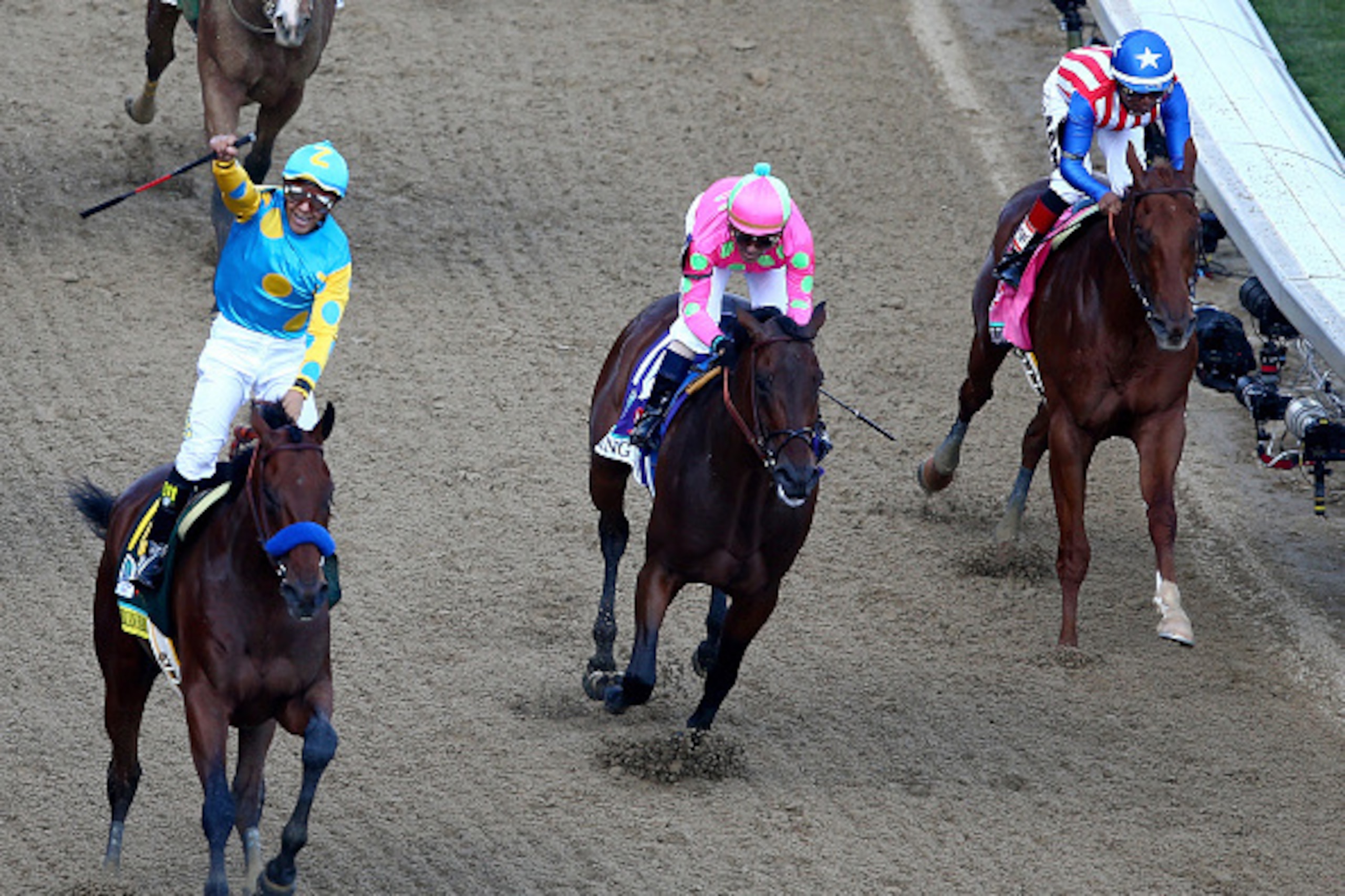 LOUISVILLE, KY - MAY 02: Jockey Victor Espinoza celebrates as he guides American Pharoah #18 after he crossed the finish line as Firing Line #10, ridden by Gary Stevens, and Dortmund #8, ridden by Martin Garcia, fiinish second and third during the 141st LOUISVILLE, KY - MAY 02: Jockey Victor Espinoza celebrates as he guides American Pharoah #18 after he crossed the finish line as Firing Line #10, ridden by Gary Stevens, and Dortmund #8, ridden by Martin Garcia, fiinish second and third during the 141st