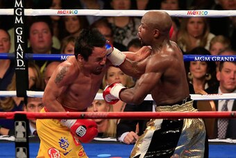 LAS VEGAS, NV - MAY 02:  Floyd Mayweather Jr. throws a right at Manny Pacquiao during their welterweight unification championship bout on May 2, 2015 at MGM Grand Garden Arena in Las Vegas, Nevada.  (Photo by Jamie Squire/Getty Images)