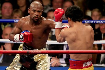LAS VEGAS, NV - MAY 02:  Floyd Mayweather Jr. throws a left at Manny Pacquiao during their welterweight unification championship bout on May 2, 2015 at MGM Grand Garden Arena in Las Vegas, Nevada.  (Photo by Jamie Squire/Getty Images)