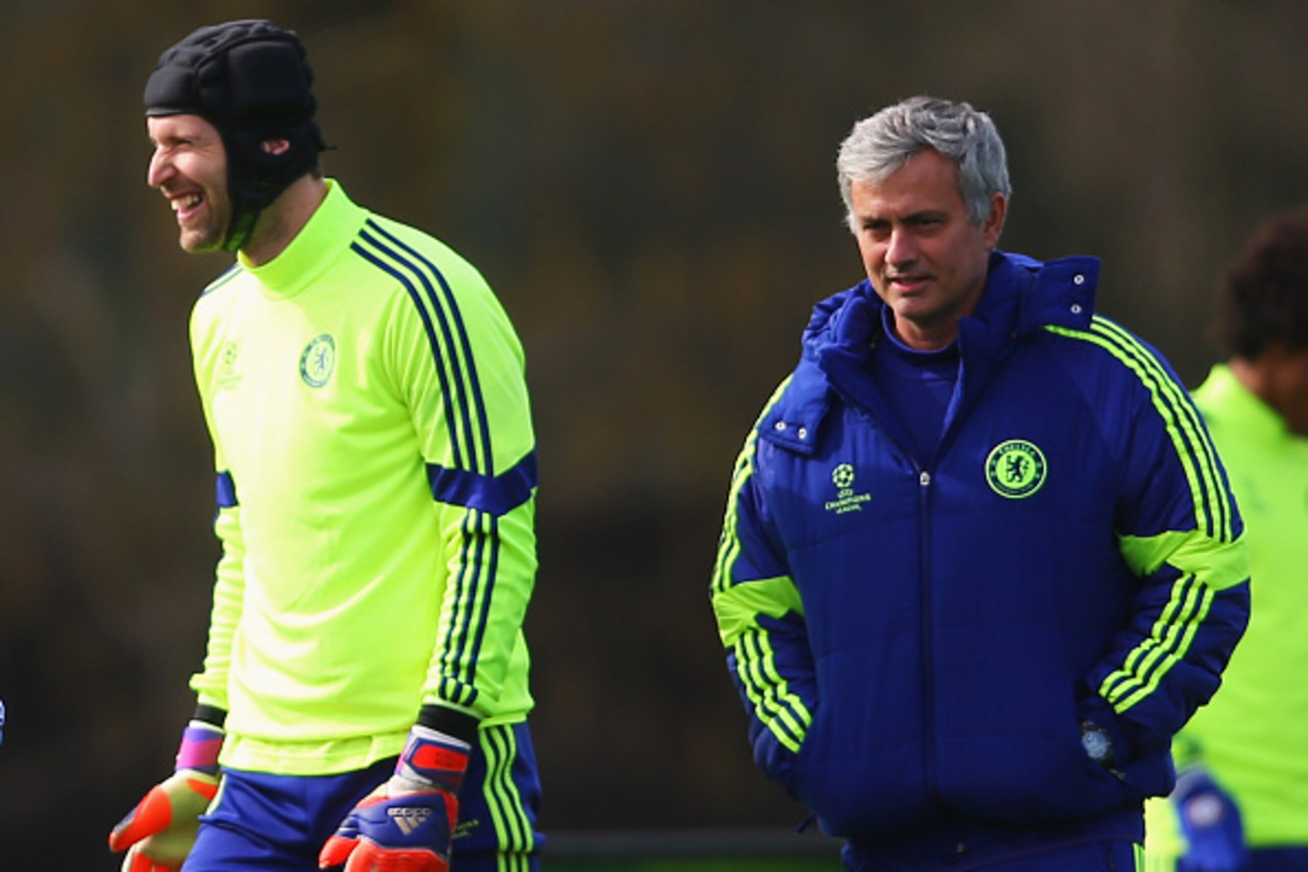 COBHAM, ENGLAND - MARCH 10:  Jose Mourinho manager of Chelsea (R) and goalkeeper Petr Cech (2R) smile during a Chelsea training session ahead of the UEFA Champions League Round of 16 second leg match against Paris Saint-Germain at Chelsea Training Ground 