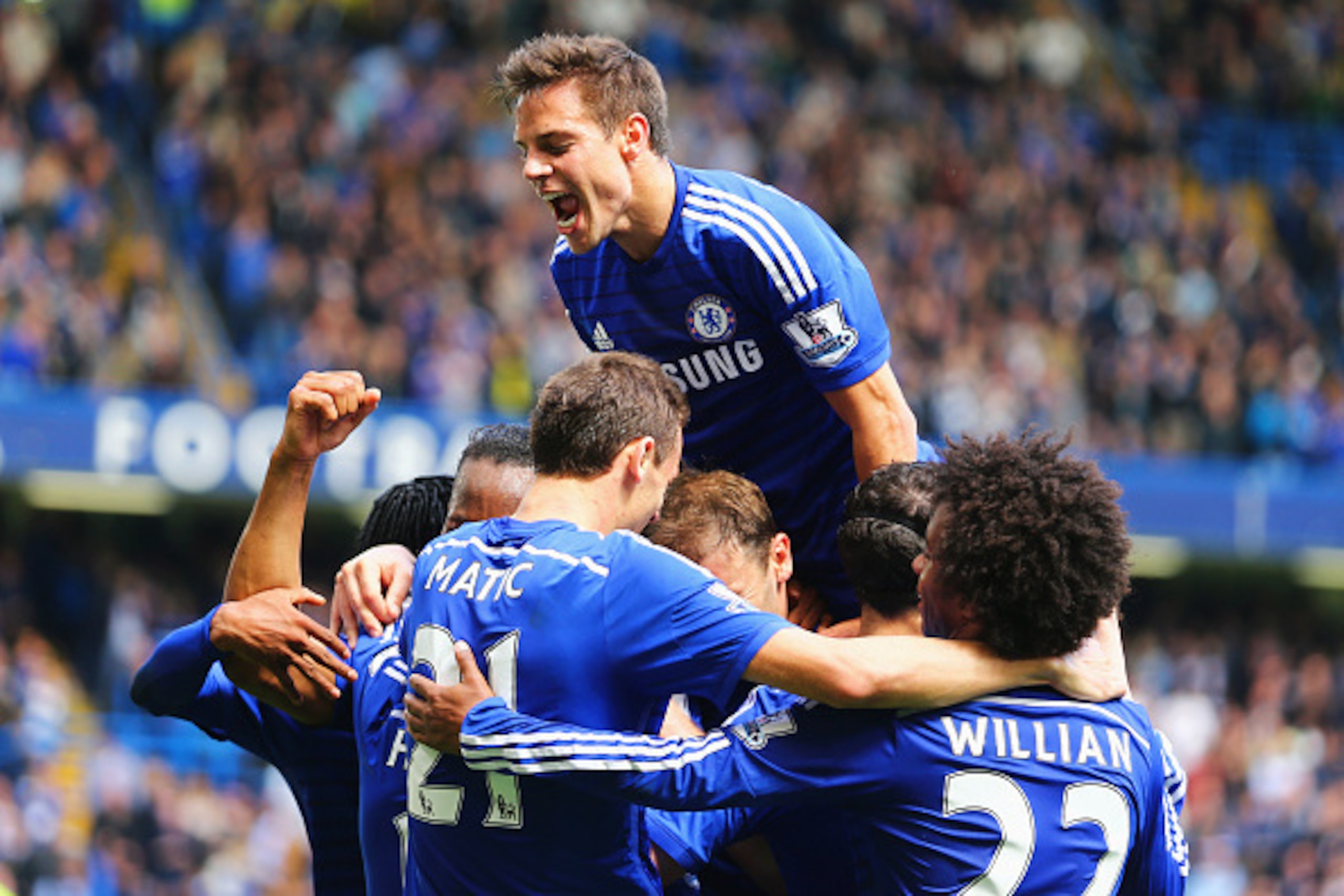 LONDON, ENGLAND - MAY 03:  Cesar Azpilicueta of Chelsea (top) and team mates mob Eden Hazard (obscured) as he scores their first goal during the Barclays Premier League match between Chelsea and Crystal Palace at Stamford Bridge on May 3, 2015 in London, 