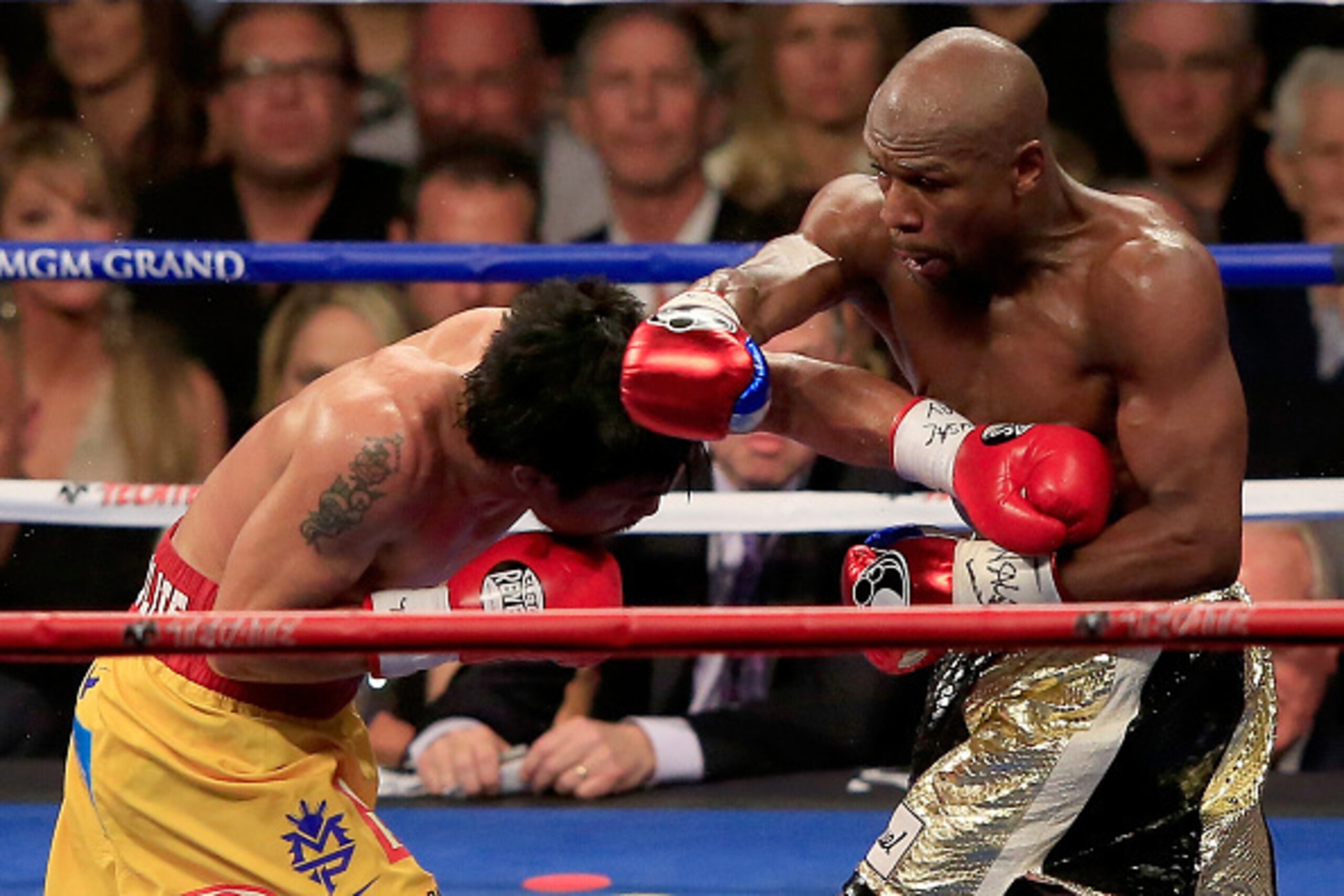 LAS VEGAS, NV - MAY 02:  Floyd Mayweather Jr. throws a right at Manny Pacquiao during their welterweight unification championship bout on May 2, 2015 at MGM Grand Garden Arena in Las Vegas, Nevada.  (Photo by Jamie Squire/Getty Images)