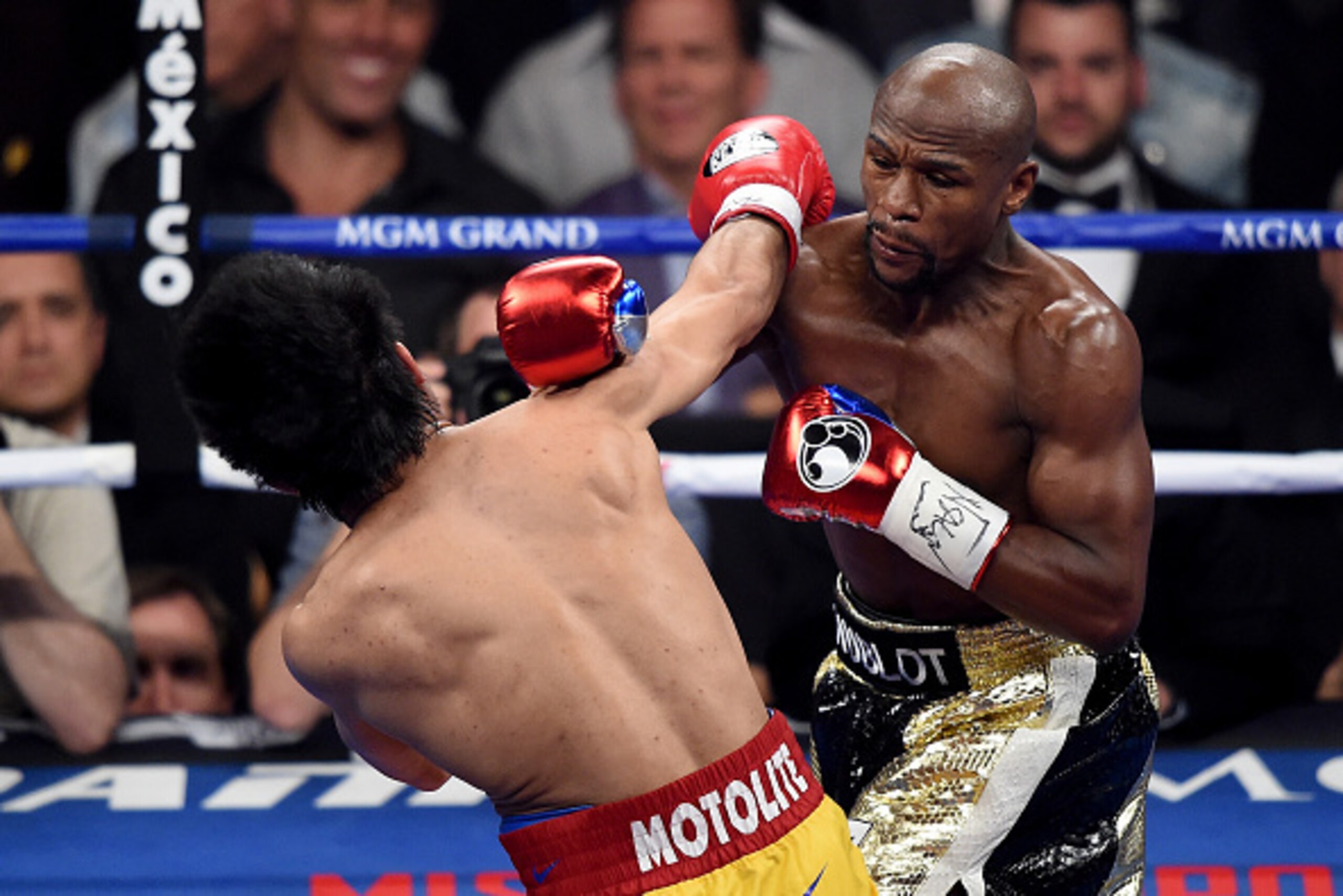 LAS VEGAS, NV - MAY 02:  Floyd Mayweather Jr. throws a right at Manny Pacquiao during their welterweight unification championship bout on May 2, 2015 at MGM Grand Garden Arena in Las Vegas, Nevada.  (Photo by Harry How/Getty Images)