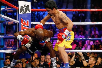 LAS VEGAS, NV - MAY 02:  Manny Pacquiao throws a right at Floyd Mayweather Jr. during their welterweight unification championship bout on May 2, 2015 at MGM Grand Garden Arena in Las Vegas, Nevada.  (Photo by Al Bello/Getty Images)