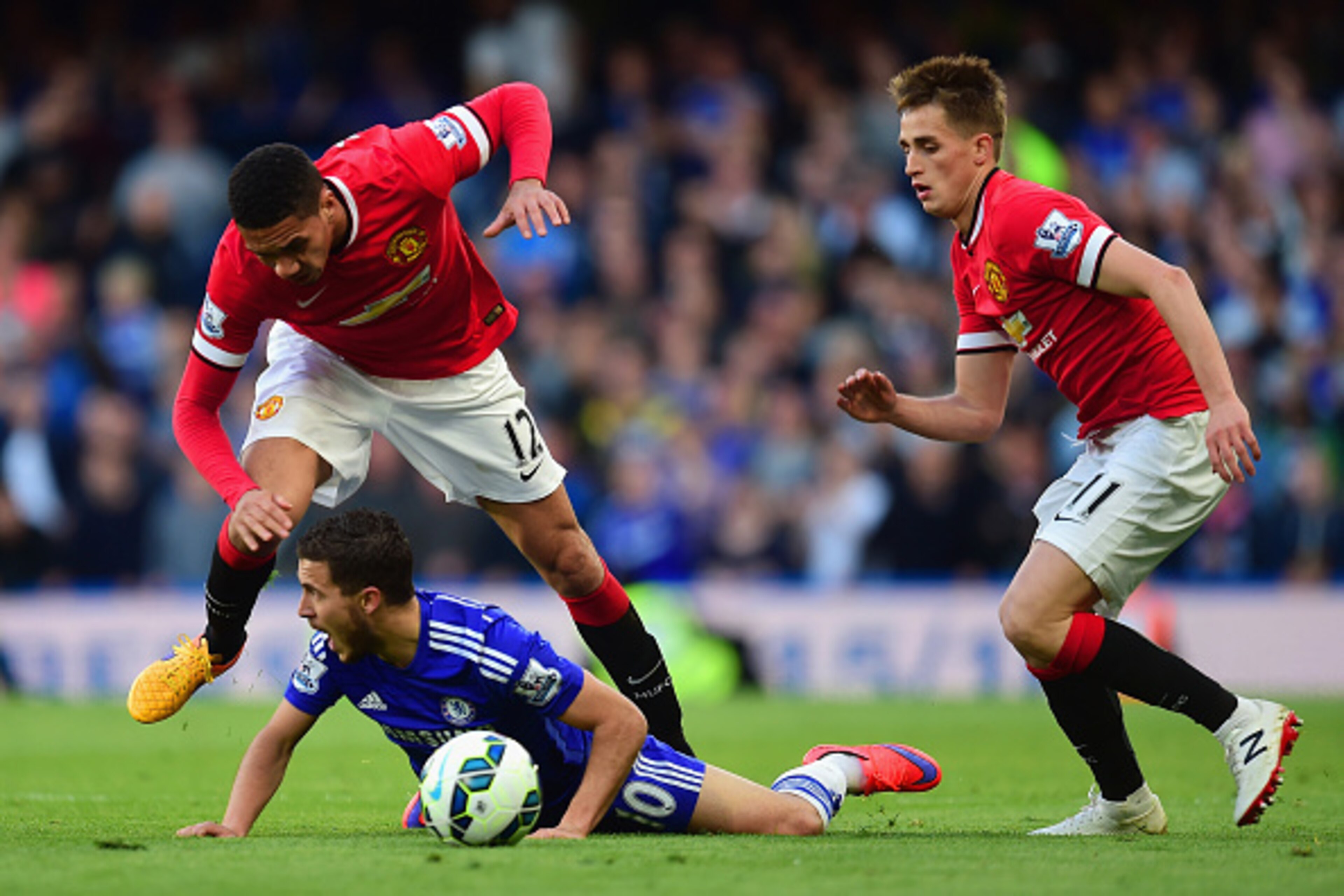 LONDON, ENGLAND - APRIL 18:  Eden Hazard of Chelsea goes to ground after a challenge from Chris Smalling of Manchester United during the Barclays Premier League match between Chelsea and Manchester United at Stamford Bridge on April 18, 2015 in London, En