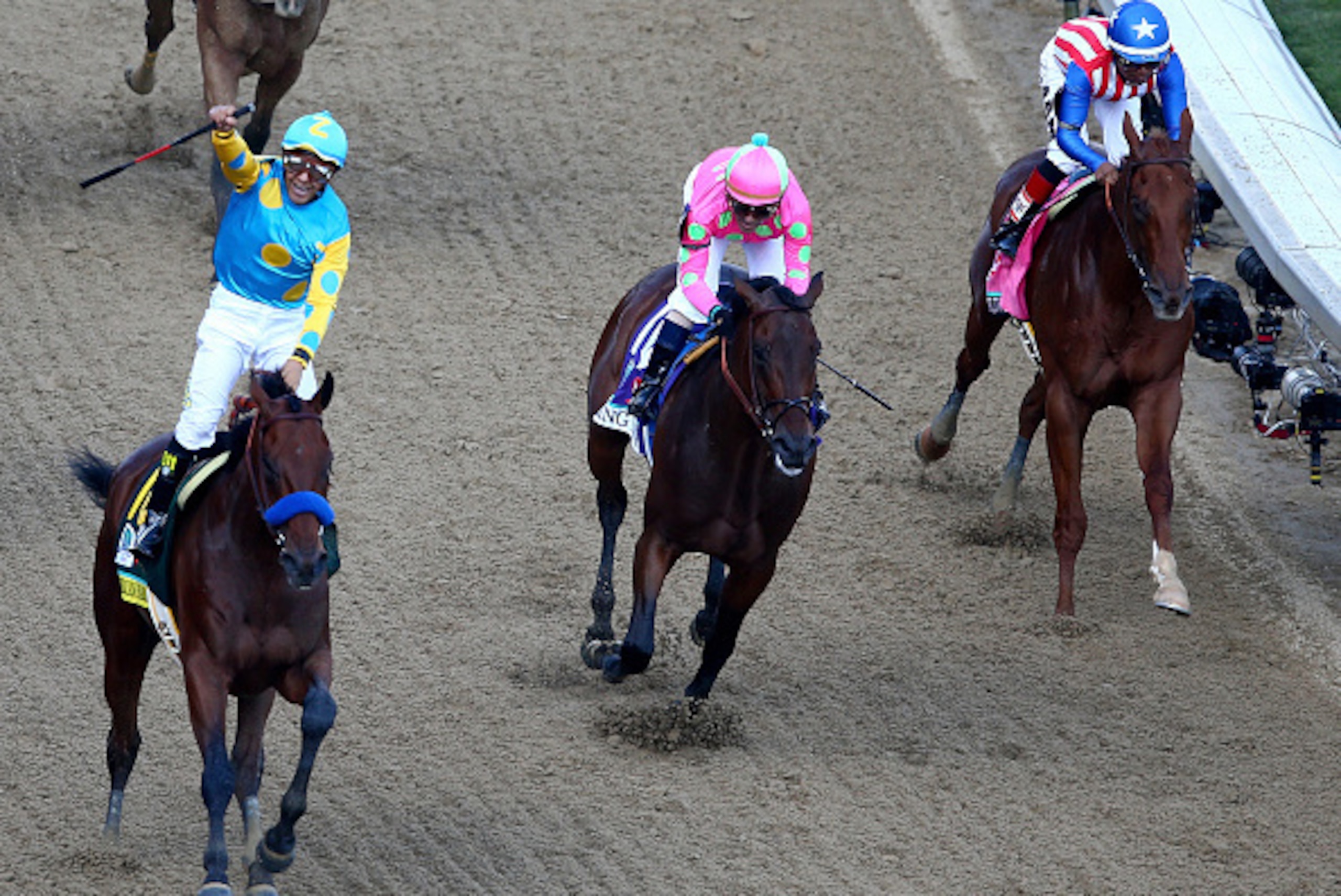 LOUISVILLE, KY - MAY 02:  Jockey Victor Espinoza celebrates as he guides American Pharoah #18 after he crossed the finish line as Firing Line #10, ridden by Gary Stevens, and Dortmund #8, ridden by Martin Garcia, fiinish second and third during the 141st 