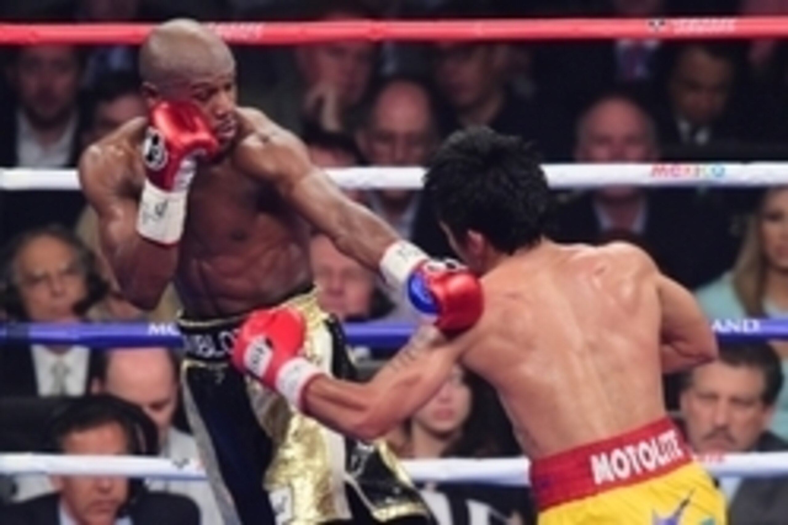 May 2, 2015; Las Vegas, NV, USA; Floyd Mayweather (black/gold trunks) and Manny Pacquiao (yellow/red trunks) box during their world welterweight championship bout at MGM Grand Garden Arena. Mayweather won via unanimous decision. Mandatory Credit: Joe Camp