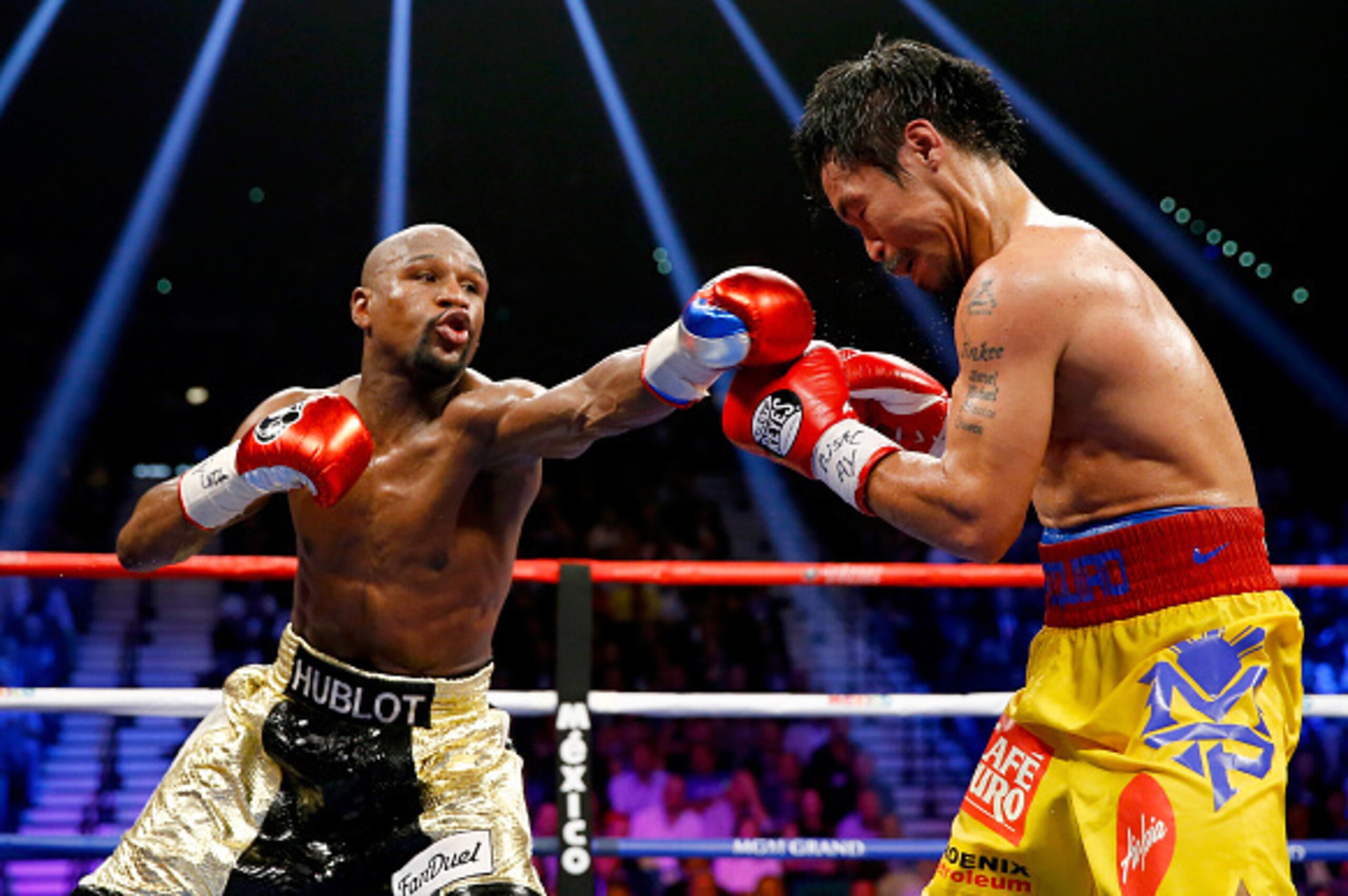 LAS VEGAS, NV - MAY 02: Floyd Mayweather Jr. throws a left at Manny Pacquiao during their welterweight unification championship bout on May 2, 2015 at MGM Grand Garden Arena in Las Vegas, Nevada. (Photo by Al Bello/Getty Images) LAS VEGAS, NV - MAY 02: Floyd Mayweather Jr. throws a left at Manny Pacquiao during their welterweight unification championship bout on May 2, 2015 at MGM Grand Garden Arena in Las Vegas, Nevada. (Photo by Al Bello/Getty Images)