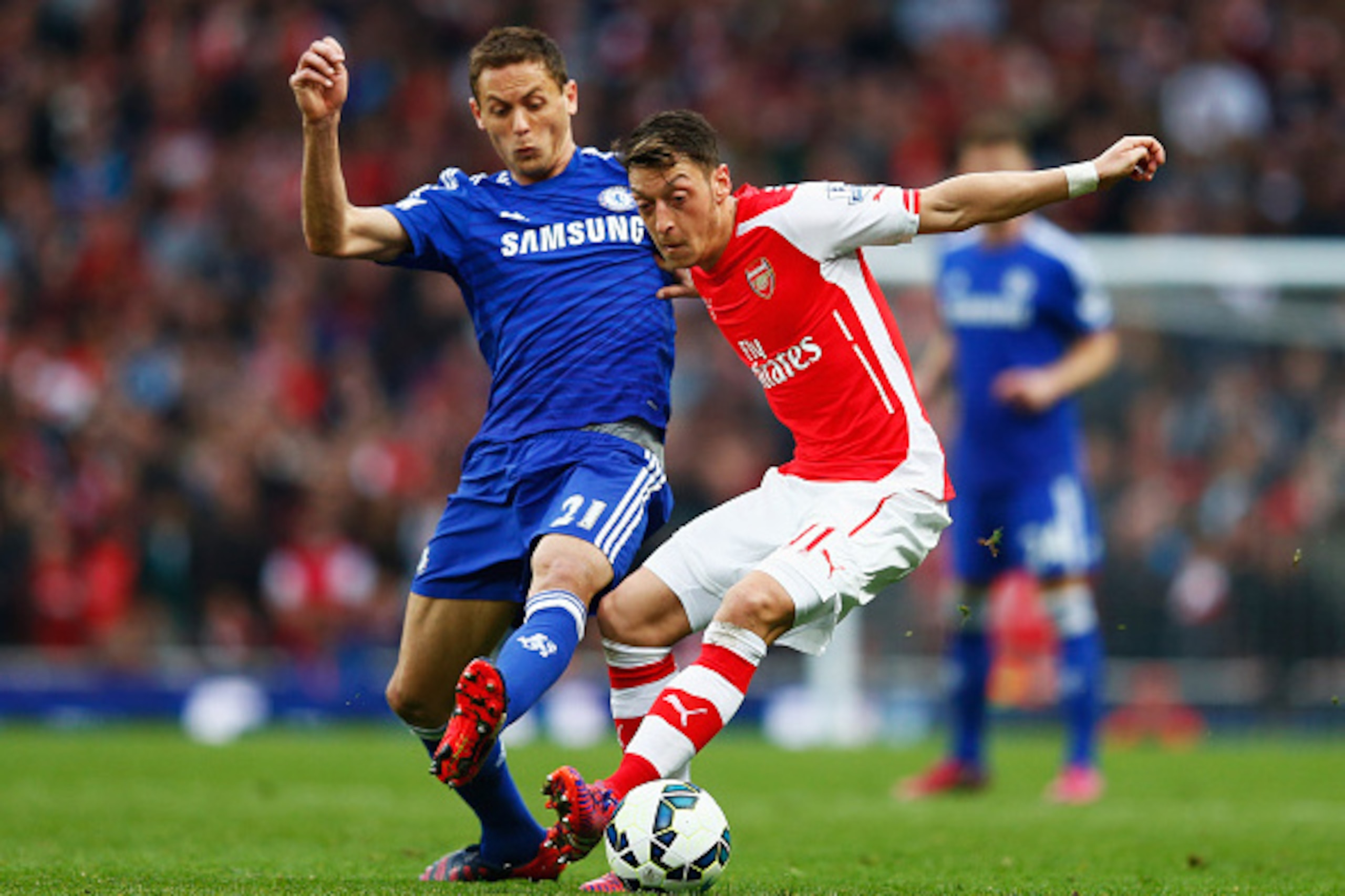 LONDON, ENGLAND - APRIL 26:  Mesut Oezil of Arsenal holds off Nemanja Matic of Chelsea during the Barclays Premier League match between Arsenal and Chelsea at Emirates Stadium on April 26, 2015 in London, England.  (Photo by Julian Finney/Getty Images)