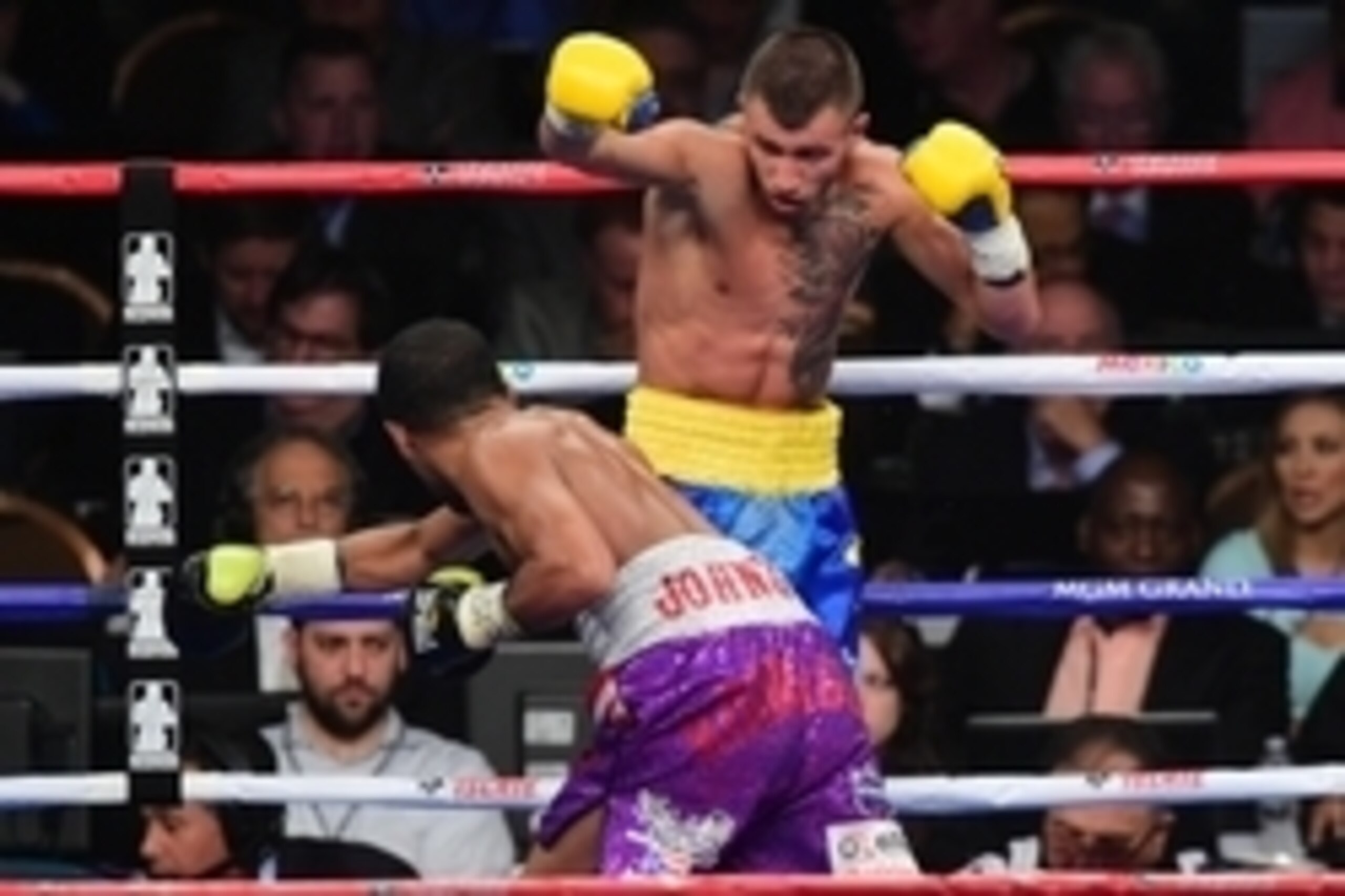 May 2, 2015; Las Vegas, NV, USA; Vasyl Lomachenko (blue/yellow trunks) and Gamalier Rodriguez (purple trunks) box during their WBO featherweight championship bout at MGM Grand Garden Arena. Mandatory Credit: Joe Camporeale-USA TODAY Sports