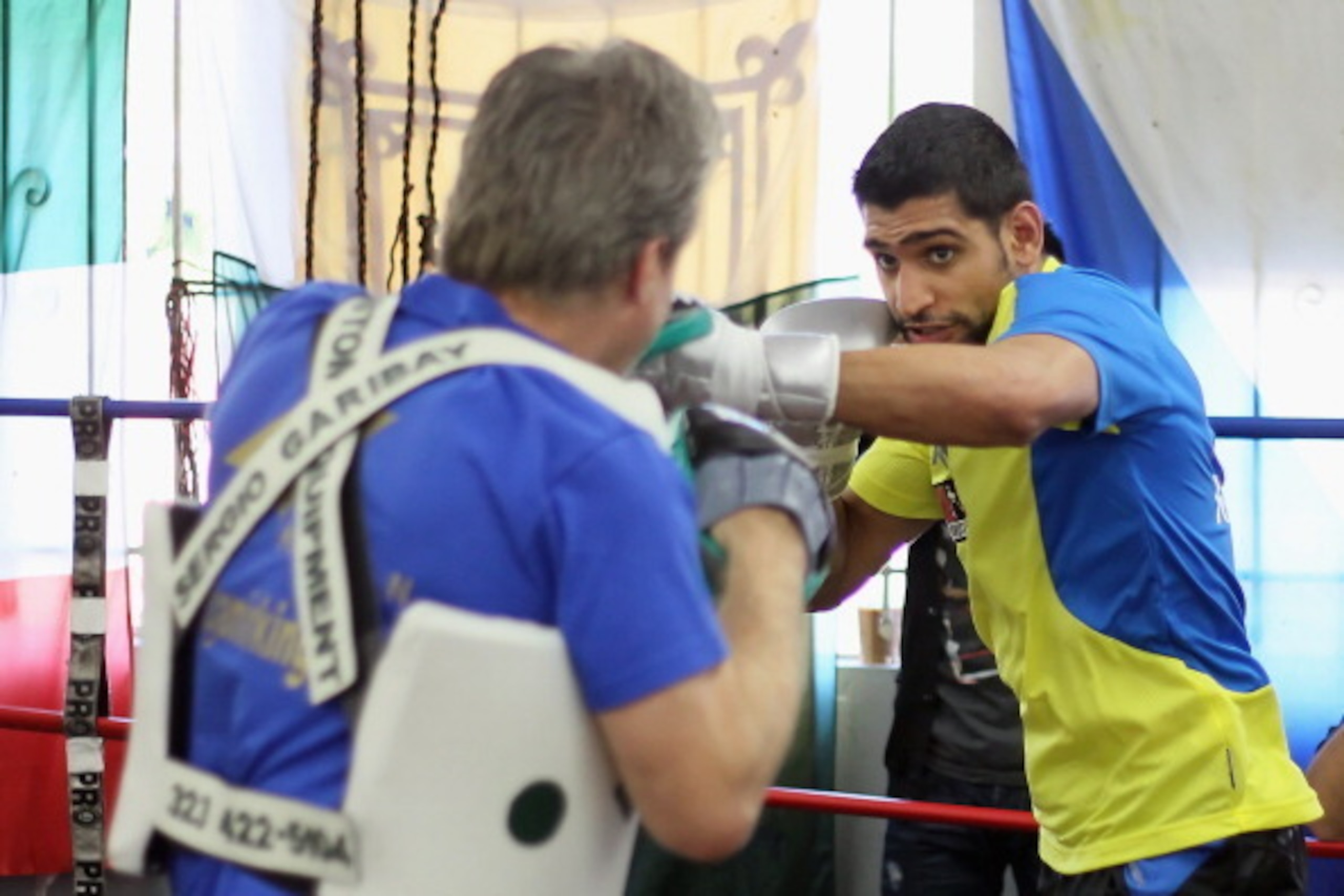 HOLLYWOOD, CA - NOVEMBER 15:  Amir Khan (R) of England and trainer Freddie Roach spar at the Wild Card Boxing Club ahead of Khan's world title defense against Lamont Peterson on November 15, 2011 in Hollywood, California.  (Photo by Jeff Gross/Getty Image