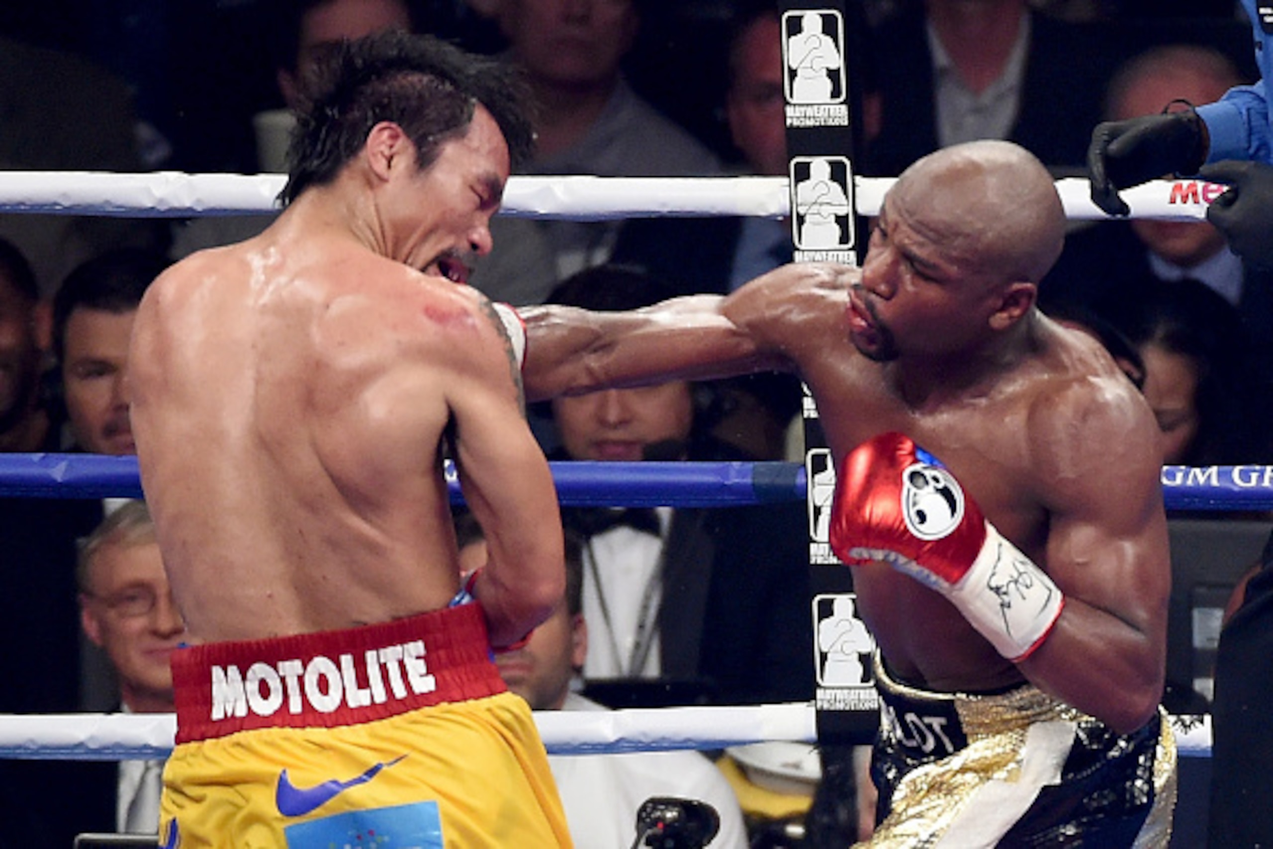LAS VEGAS, NV - MAY 02:  Floyd Mayweather Jr. (R) throws a right at Manny Pacquiao during their welterweight unification championship bout on May 2, 2015 at MGM Grand Garden Arena in Las Vegas, Nevada.  (Photo by Jason Merritt/Getty Images)
