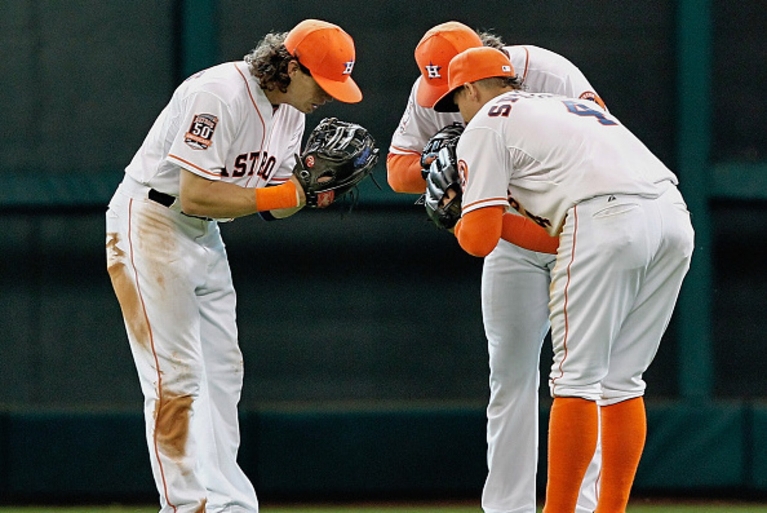 HOUSTON, TX - APRIL 19: Colby Rasmus #28 of the Houston Astros, left, Jake Marisnick #6, center, and George Springer #4 celebrate afte the final out as the Houston Astros beat the Los Angeles Angels of Anaheim 4-3 at Minute Maid Park on April 19, 2015 in 