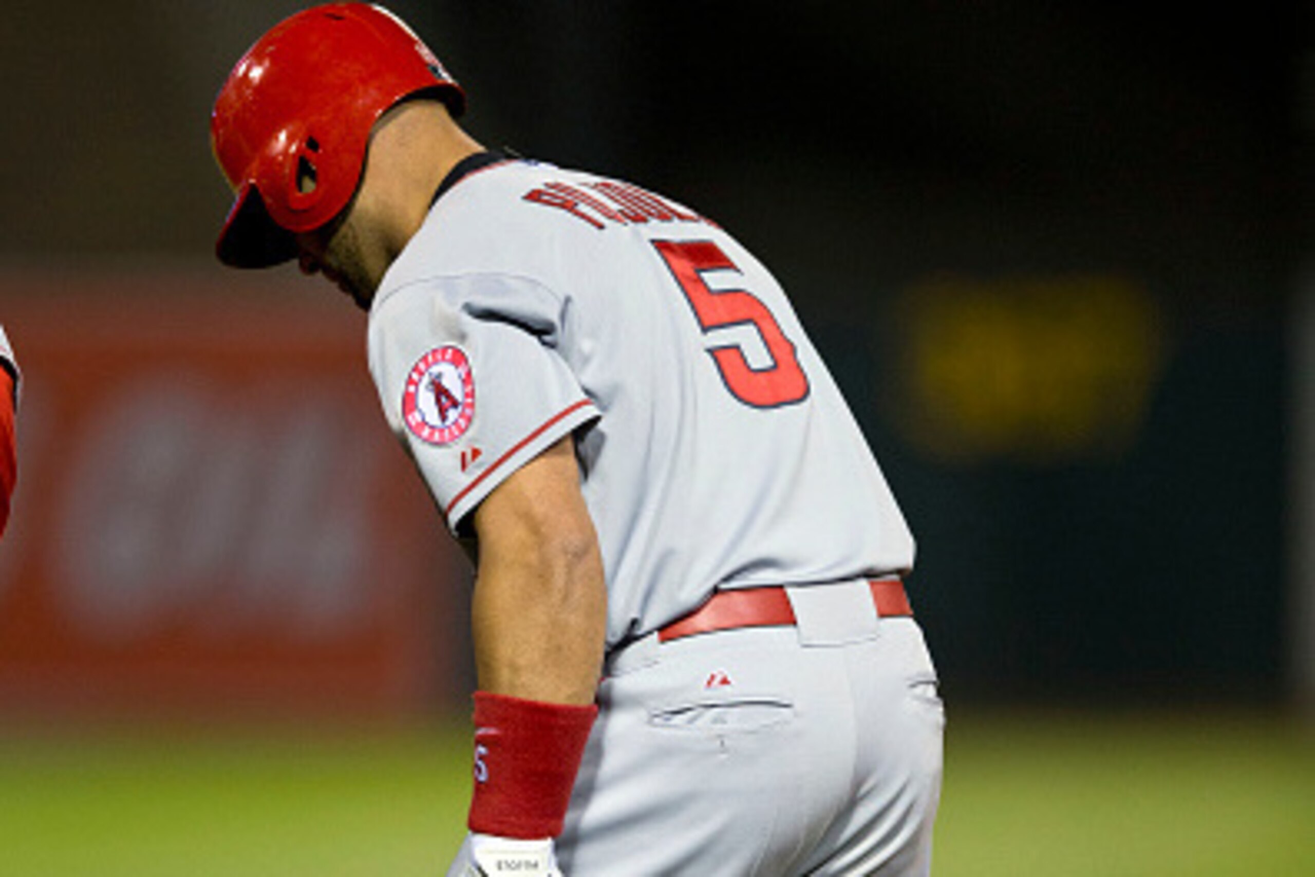 OAKLAND, CA - APRIL 29:  Albert Pujols #5 of the Los Angeles Angels of Anaheim holds his leg at first base after hitting a single against the Oakland Athletics during the sixth inning at O.co Coliseum on April 29, 2015 in Oakland, California. (Photo by Ja