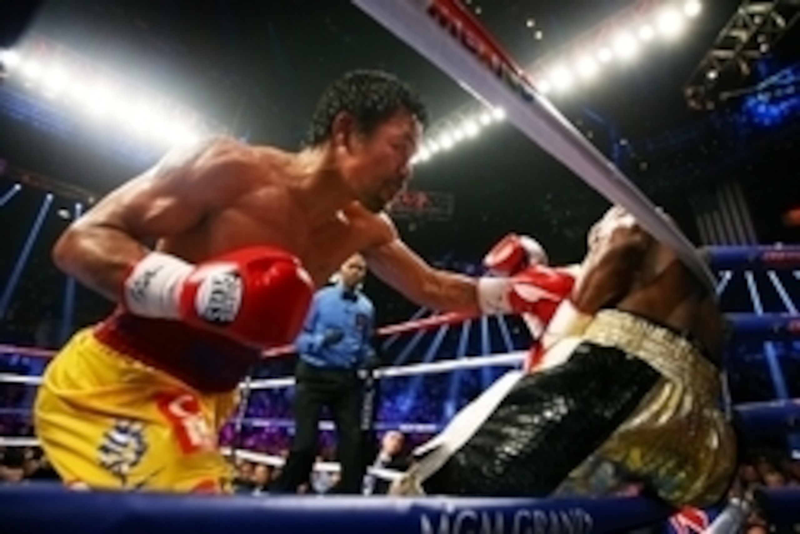 May 2, 2015; Las Vegas, NV, USA; Manny Pacquiao (left) punches Floyd Mayweather against the ropes during their boxing bout at the MGM Grand Garden Arena. Mandatory Credit: Mark J. Rebilas-USA TODAY Sports