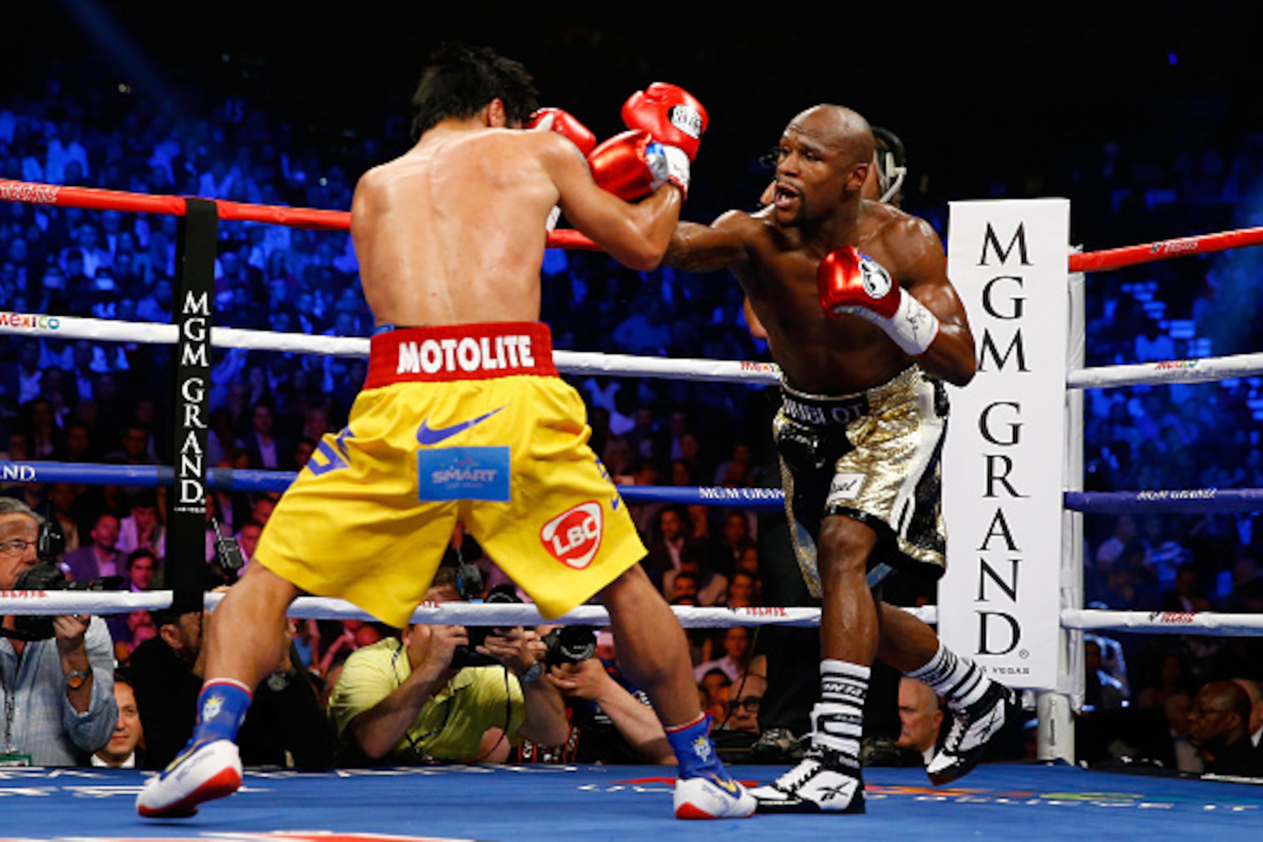 LAS VEGAS, NV - MAY 02:  Floyd Mayweather Jr. and Manny Pacquiao exchange punches during their welterweight unification championship bout on May 2, 2015 at MGM Grand Garden Arena in Las Vegas, Nevada.  (Photo by Al Bello/Getty Images)