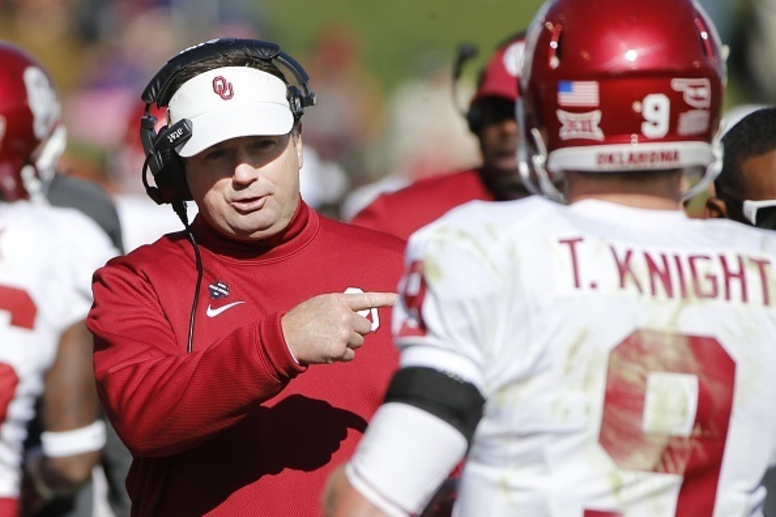 AMES, IA - NOVEMBER 1: Head coach Bob Stoops of the Oklahoma Sooners coaches quarterback Trevor Knight #9 of the Oklahoma Sooners on the sidelines in the first half of play against the Iowa State Cyclones at Jack Trice Stadium on November 1, 2014 in Ames, AMES, IA - NOVEMBER 1: Head coach Bob Stoops of the Oklahoma Sooners coaches quarterback Trevor Knight #9 of the Oklahoma Sooners on the sidelines in the first half of play against the Iowa State Cyclones at Jack Trice Stadium on November 1, 2014 in Ames,