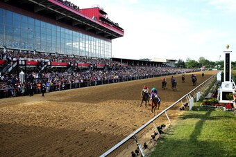 BALTIMORE, MD - MAY 17:  California Chrome #3, ridden by Victor Espinoza, races accross the finishline to win the 139th running of the Preakness Stakes at Pimlico Race Course on May 17, 2014 in Baltimore, Maryland.  (Photo by Matthew Stockman/Getty Images