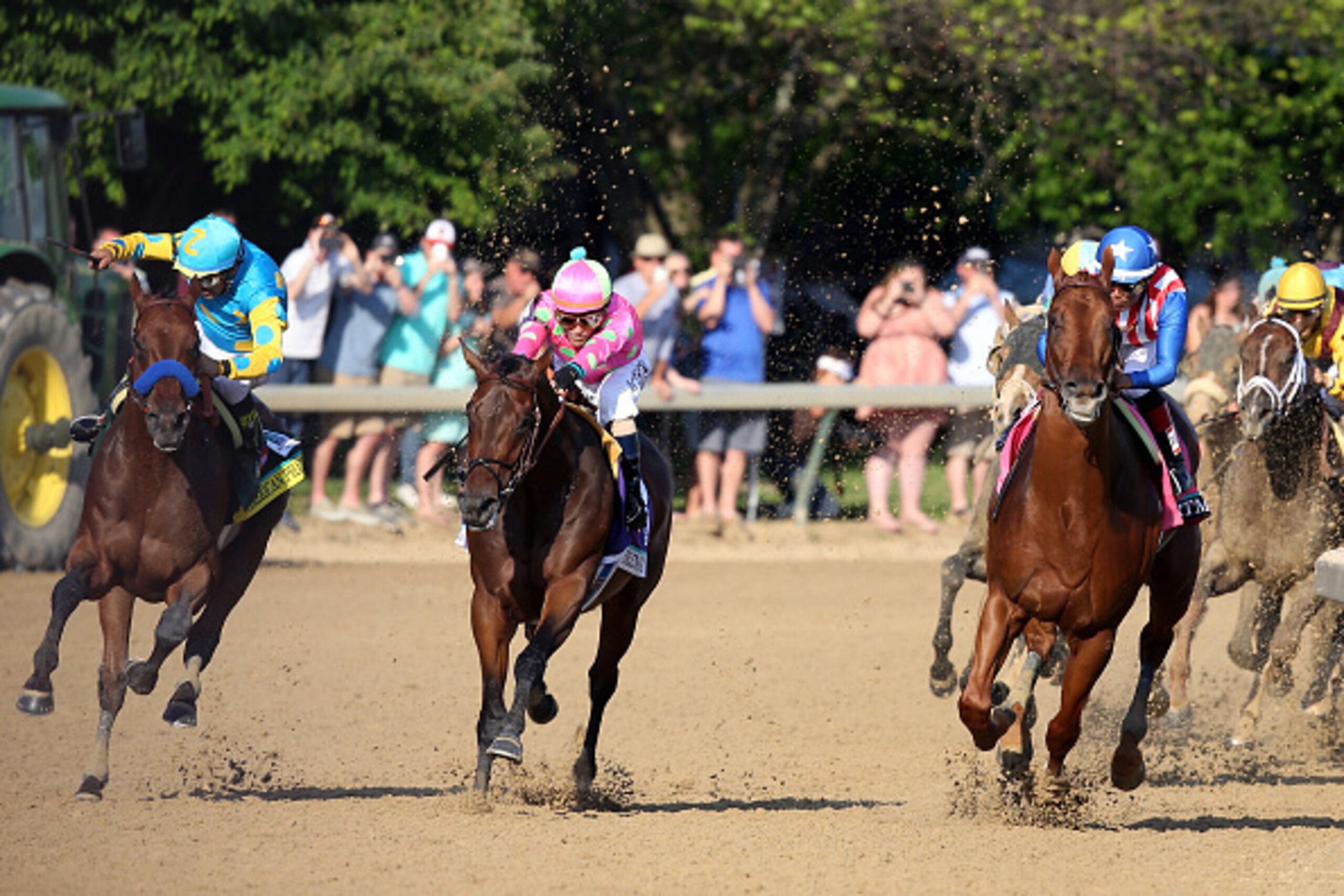 LOUISVILLE, KY - MAY 02:  American Pharoah #18, ridden by Victor Espinoza, races Firing Line #10, ridden by Gary Stevens, out of turn 4 during the 141st running of the Kentucky Derby at Churchill Downs on May 2, 2015 in Louisville, Kentucky.  (Photo by An