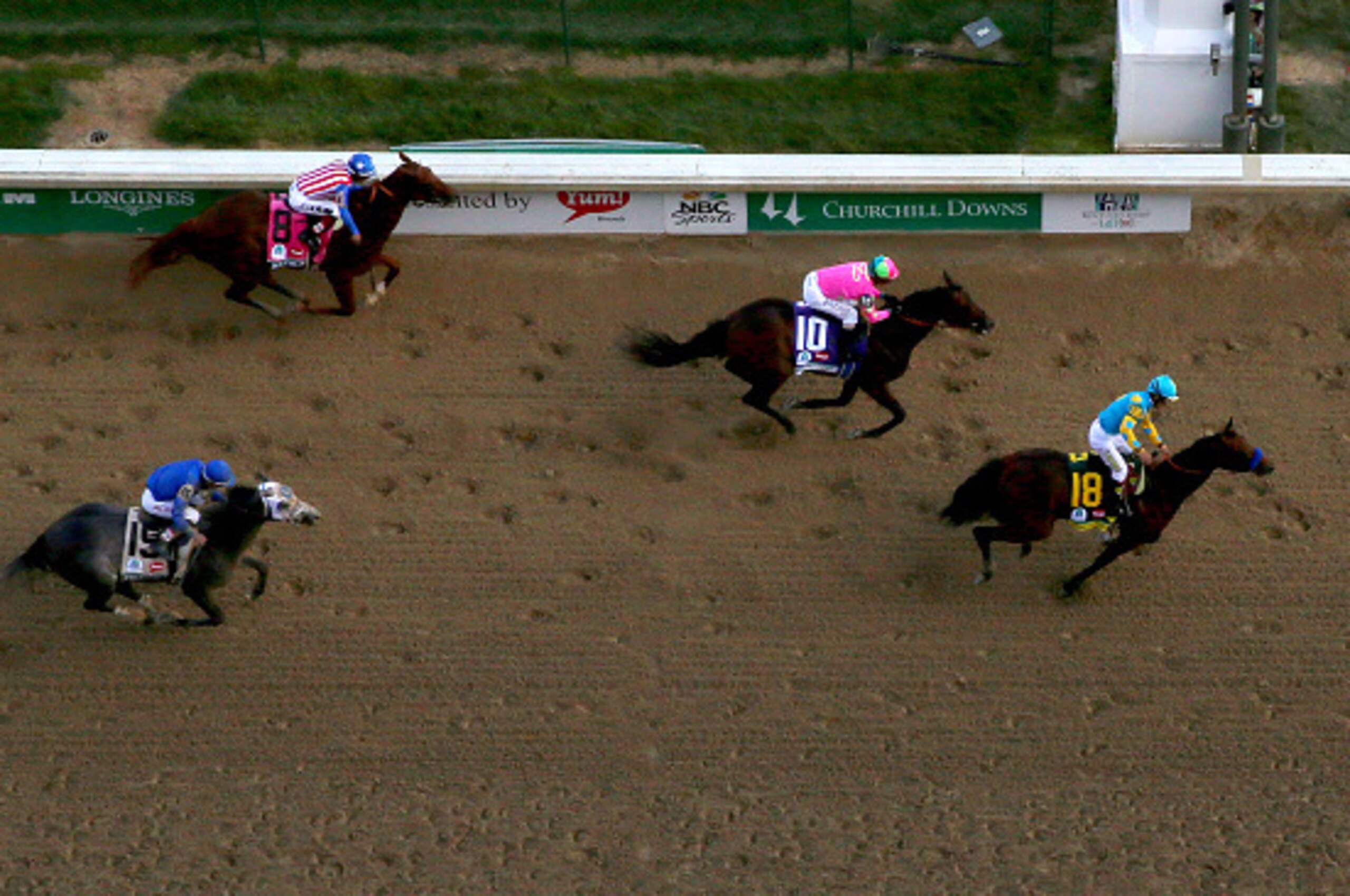 LOUISVILLE, KY - MAY 02:  Jockey Victor Espinoza celebrates as he guides American Pharoah #18 after crossing the finish line to win the 141st running of the Kentucky Derby at Churchill Downs on May 2, 2015 in Louisville, Kentucky.  (Photo by Elsa/Getty Im