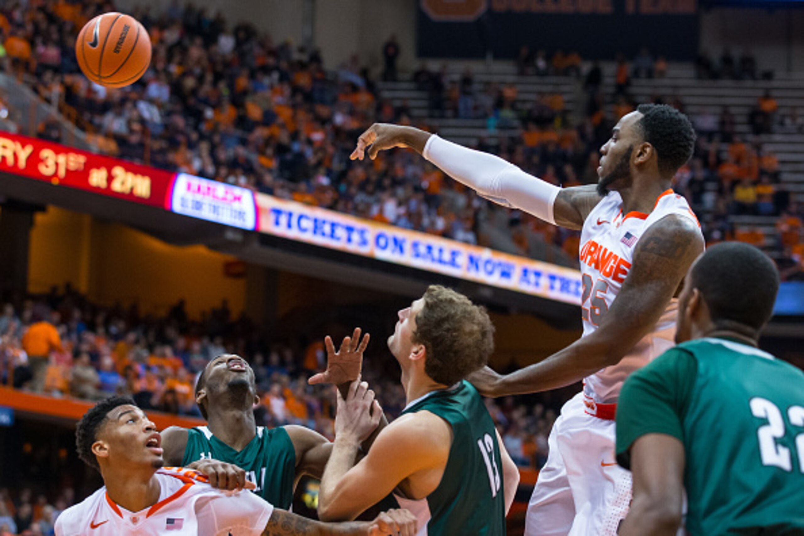 SYRACUSE, NY - NOVEMBER 25:  Rakeem Christmas #25 of the Syracuse Orange passes the ball to the outside against the Loyola (MD) Greyhounds on November 25, 2014 at The Carrier Dome in Syracuse, New York. Syracuse defeats Loyola (MD) 70-37.  (Photo by Brett