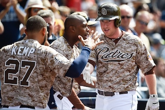 SAN DIEGO, CA - MAY 3:  Jedd Gyorko #9 of the San Diego Padres, right, is congratulated by Matt Kemp #27 after he hit a two-run home run during the sixth inning of a baseball game against the Colorado Rockies at Petco Park May 3, 2015 in San Diego, Califo