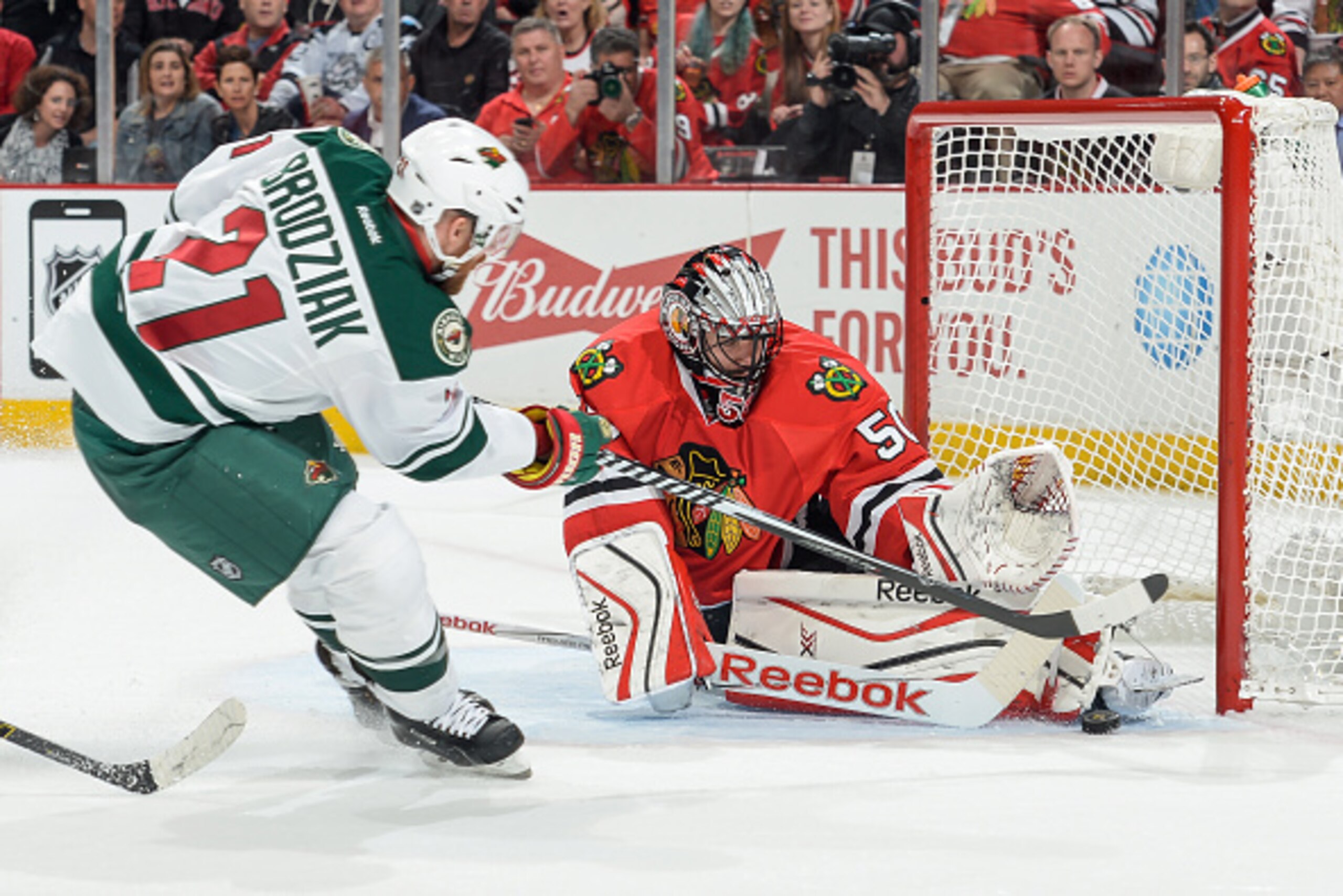 CHICAGO, IL - MAY 03:  Goalie Corey Crawford #50 of the Chicago Blackhawks stops the shot taken by Kyle Brodziak #21 of the Minnesota Wild in Game Two of the Western Conference Semifinals during the 2015 NHL Stanley Cup Playoffs at the United Center on Ma