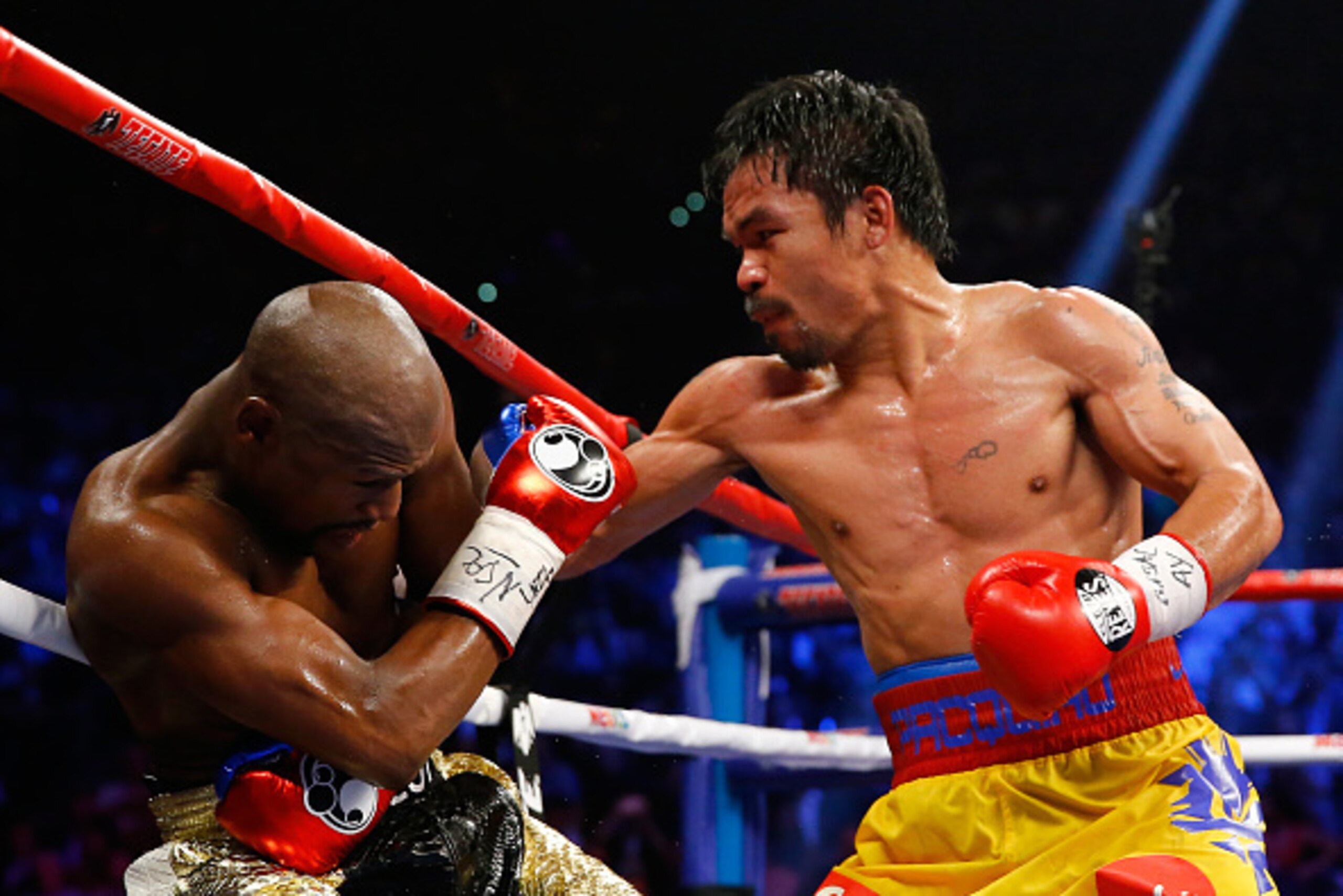 LAS VEGAS, NV - MAY 02: Manny Pacquiao throws a right at Floyd Mayweather Jr. during their welterweight unification championship bout on May 2, 2015 at MGM Grand Garden Arena in Las Vegas, Nevada. (Photo by Al Bello/Getty Images) LAS VEGAS, NV - MAY 02: Manny Pacquiao throws a right at Floyd Mayweather Jr. during their welterweight unification championship bout on May 2, 2015 at MGM Grand Garden Arena in Las Vegas, Nevada. (Photo by Al Bello/Getty Images)