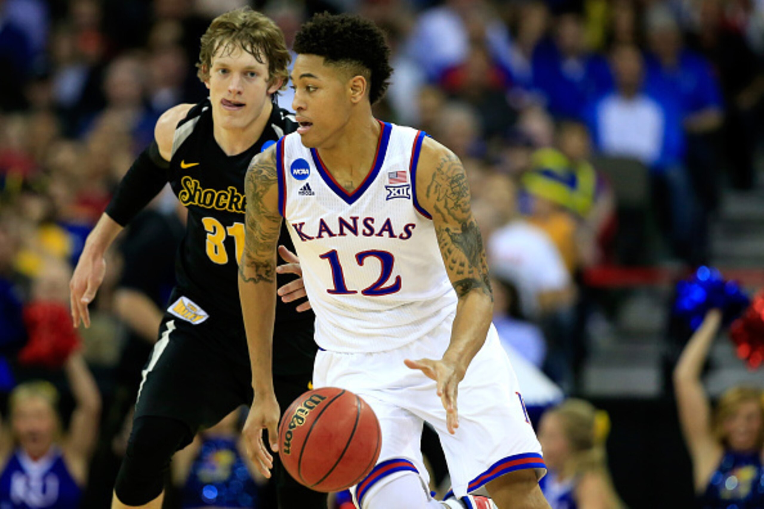 OMAHA, NE - MARCH 22: Kelly Oubre Jr. #12 of the Kansas Jayhawks dribbles past Ron Baker #31 of the Wichita State Shockers in the first half during the third round of the 2015 NCAA Men's Basketball Tournament at the CenturyLink Center on March 22, 2015 in