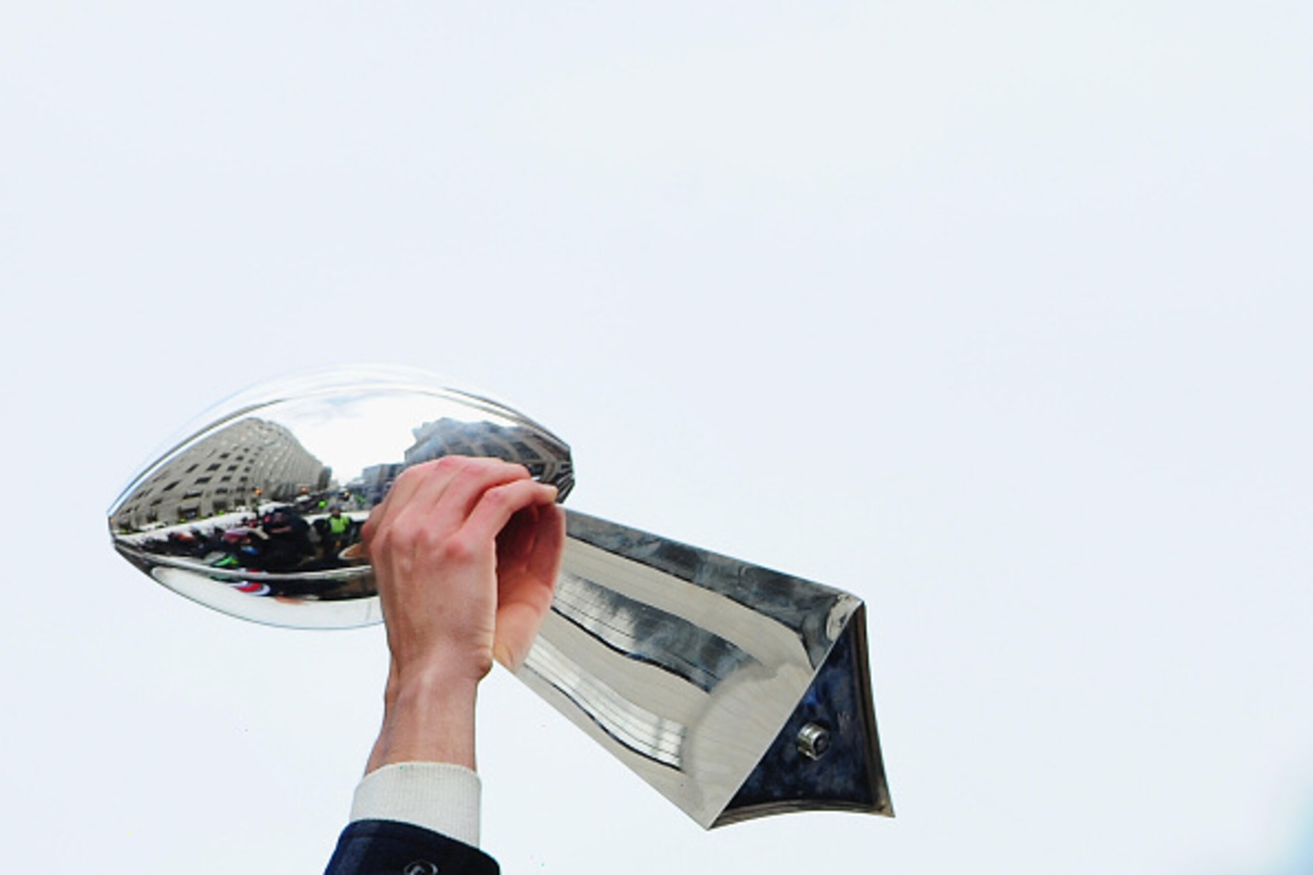 BOSTON, MA - FEBRUARY 04:  The Vince Lombardi trophy is hoisted during the New England Patriots Super Bowl victory parade on February 4, 2015 in Boston, Massachusetts. The Patriots defeated the Seattle Seahawks 28-24 in Super Bowl XLIX. (Photo by Billie W