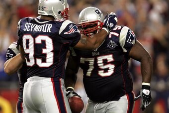 FOXBORO, MA - SEPTEMBER 8:  Defensive lineman Vince Wilfork #75 of the New England Patriots is congratulated by teammate Richard Seymour #93 after an interception against the Oakland Raiders during the 2005 NFL opening game at Gillette Stadium on Septembe