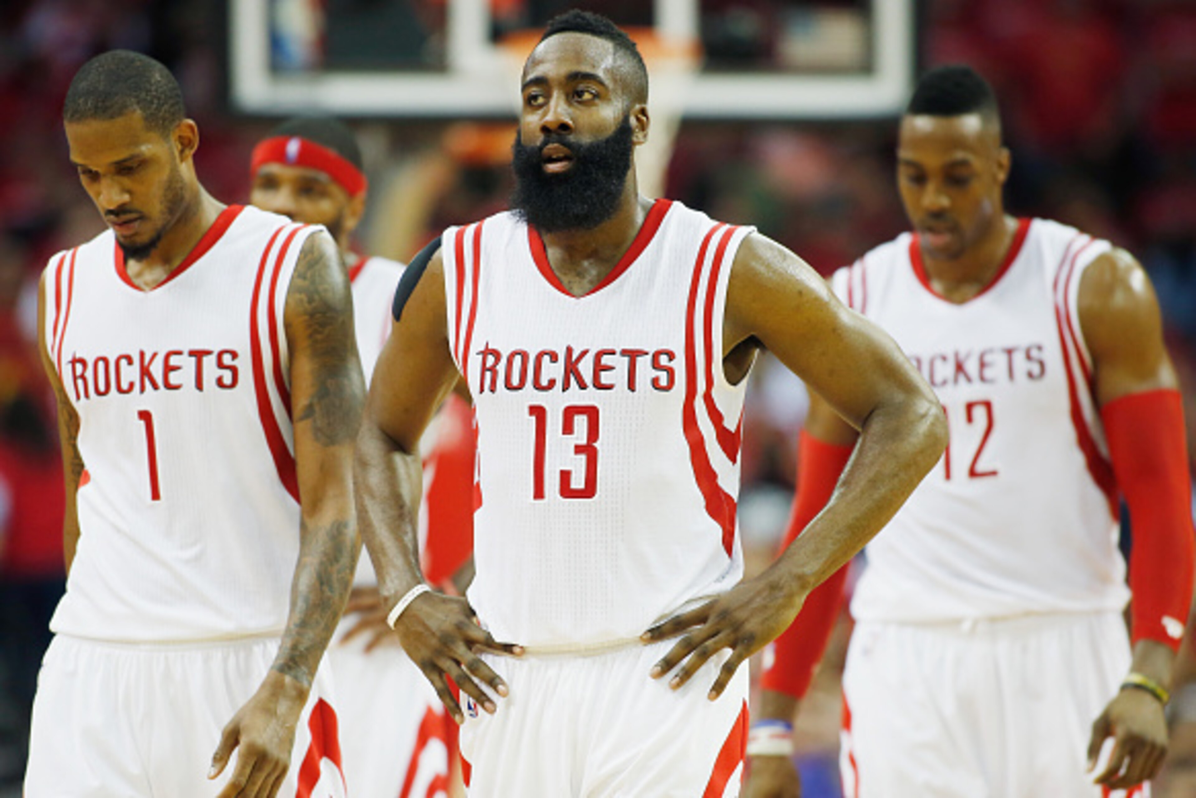 HOUSTON, TX - MAY 04:  Trevor Ariza #1, James Harden #13  and Dwight Howard #12 of the Houston Rockets walk to the bench against the Los Angeles Clippers during Game One in the Western Conference Semifinals of the 2015 NBA Playoffs on May 4, 2015 at the T