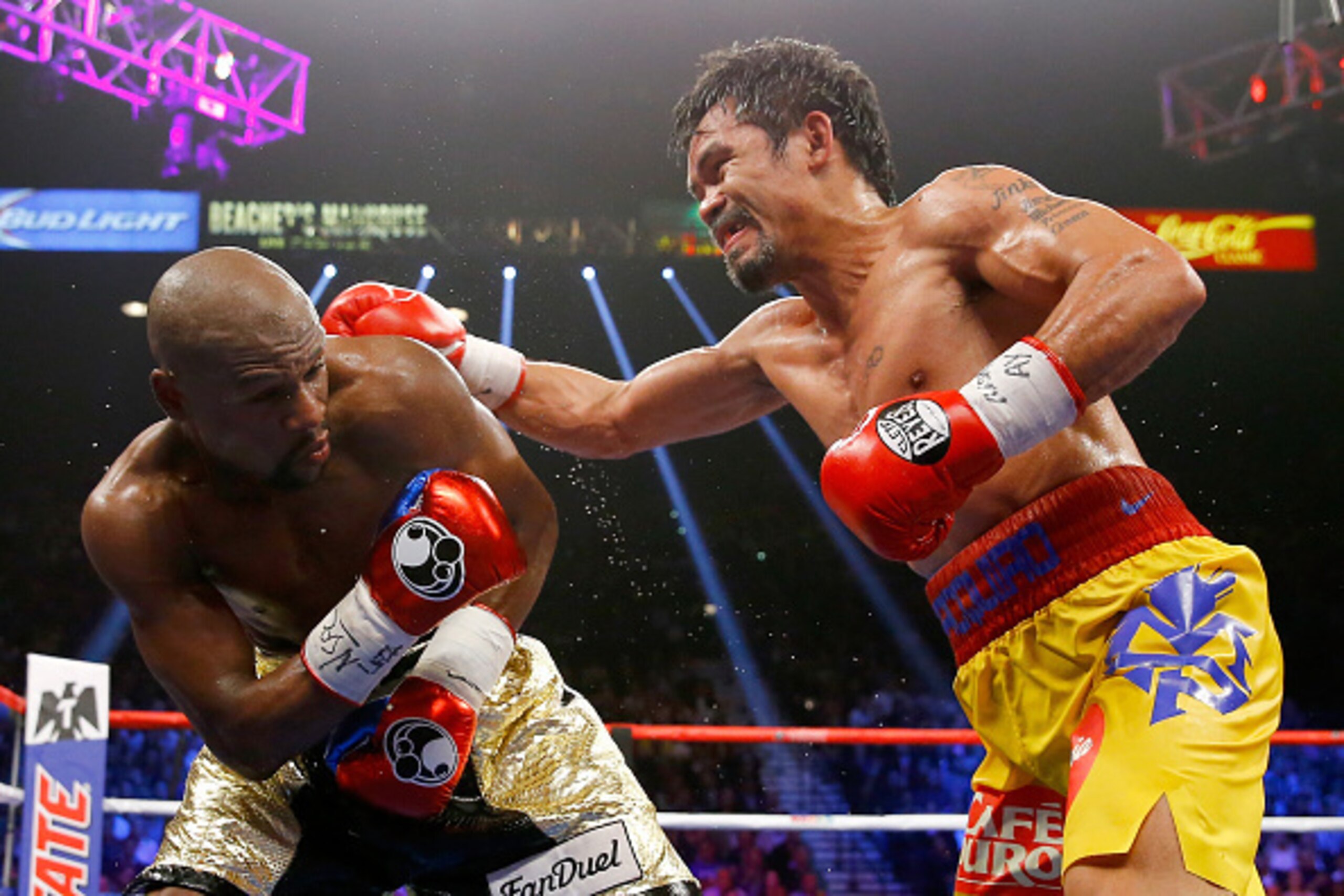 LAS VEGAS, NV - MAY 02:  Manny Pacquiao throws a right at Floyd Mayweather Jr. during their welterweight unification championship bout on May 2, 2015 at MGM Grand Garden Arena in Las Vegas, Nevada.  (Photo by Al Bello/Getty Images)