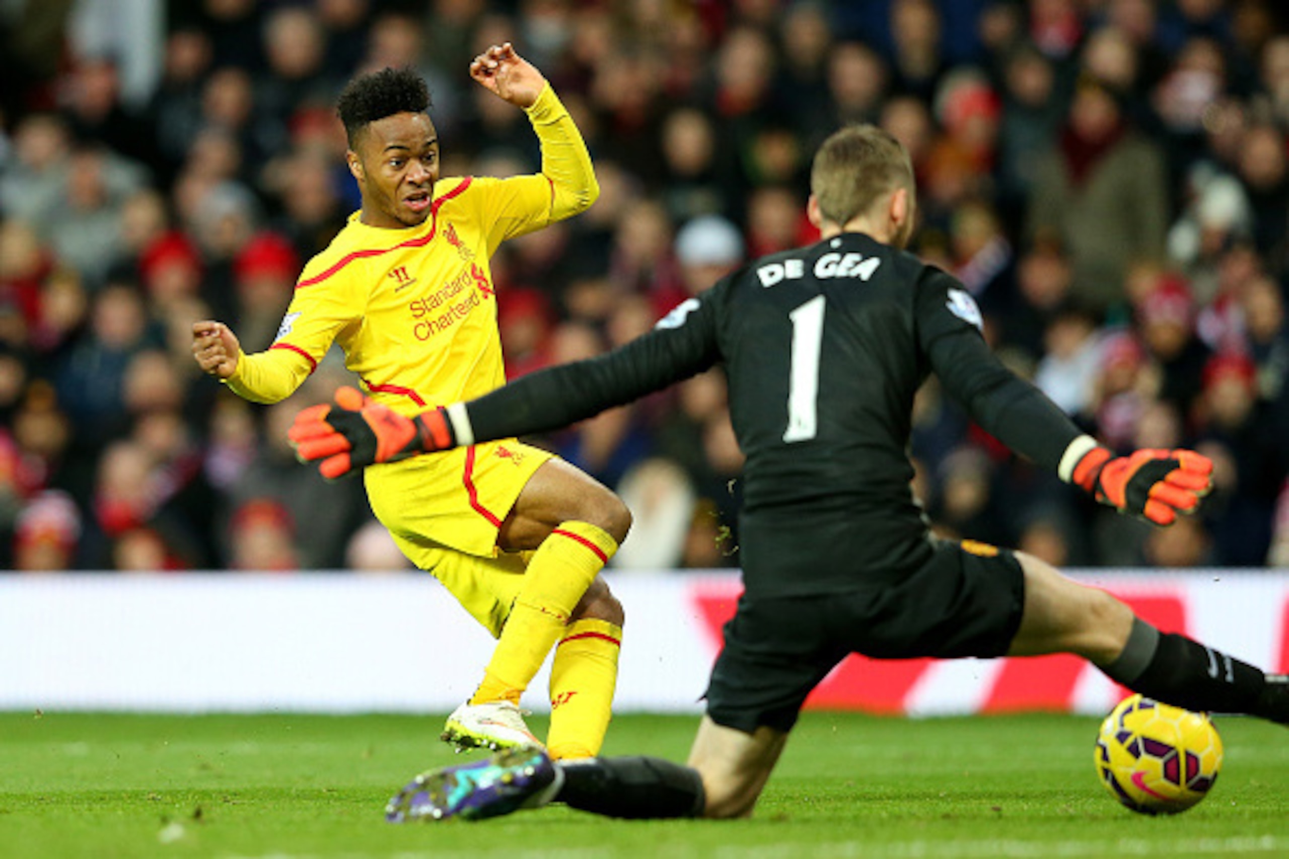 MANCHESTER, ENGLAND - DECEMBER 14: Dvid De Gea of Manchester United saves the attempt on goal of Raheem Sterling of Liverpool in a one on one situation during the Barclays Premier League match between Manchester United and Liverpool at Old Trafford on De MANCHESTER, ENGLAND - DECEMBER 14: Dvid De Gea of Manchester United saves the attempt on goal of Raheem Sterling of Liverpool in a one on one situation during the Barclays Premier League match between Manchester United and Liverpool at Old Trafford on De