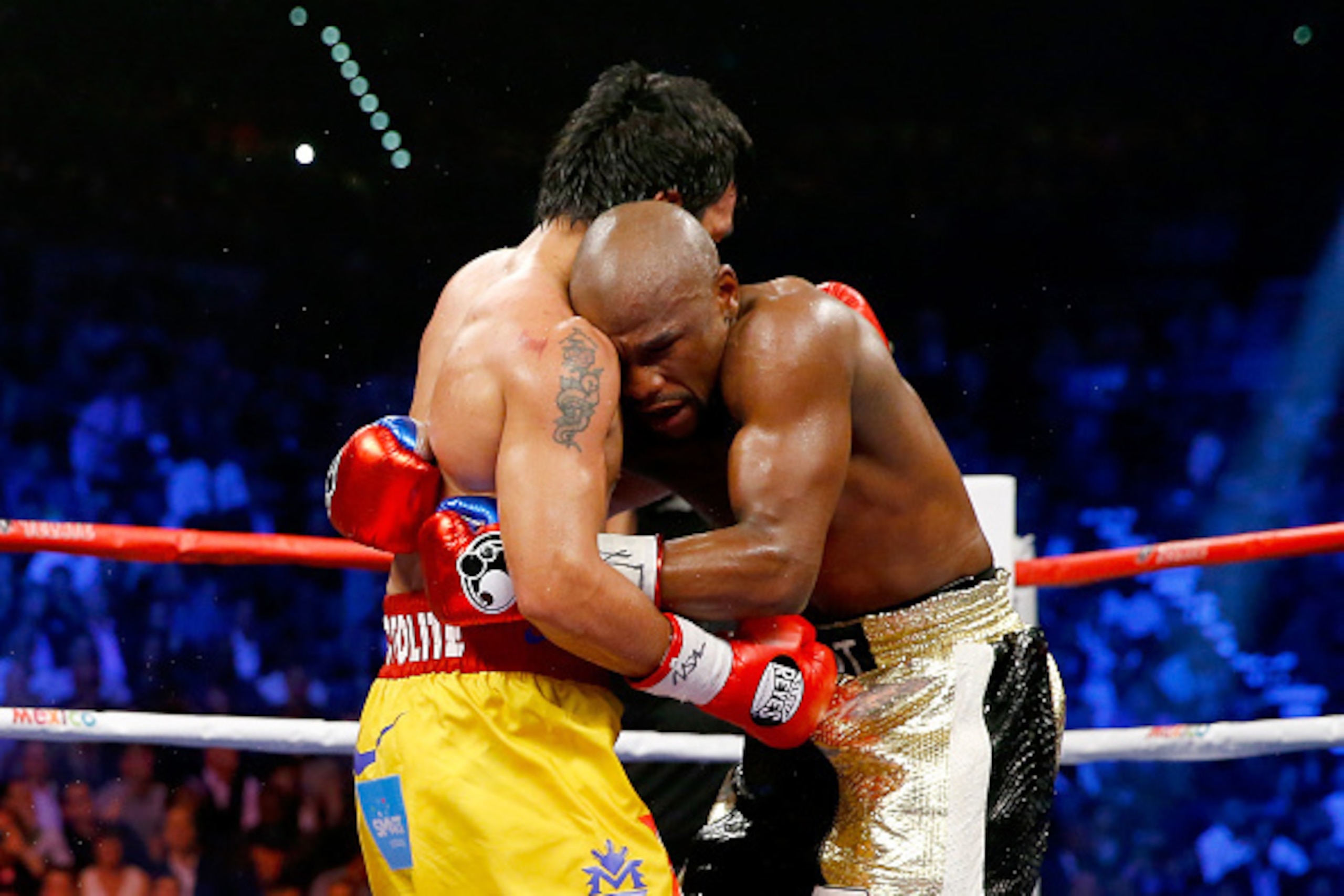 LAS VEGAS, NV - MAY 02:  Floyd Mayweather Jr. and Manny Pacquiao hold during their welterweight unification championship bout on May 2, 2015 at MGM Grand Garden Arena in Las Vegas, Nevada.  (Photo by Al Bello/Getty Images)