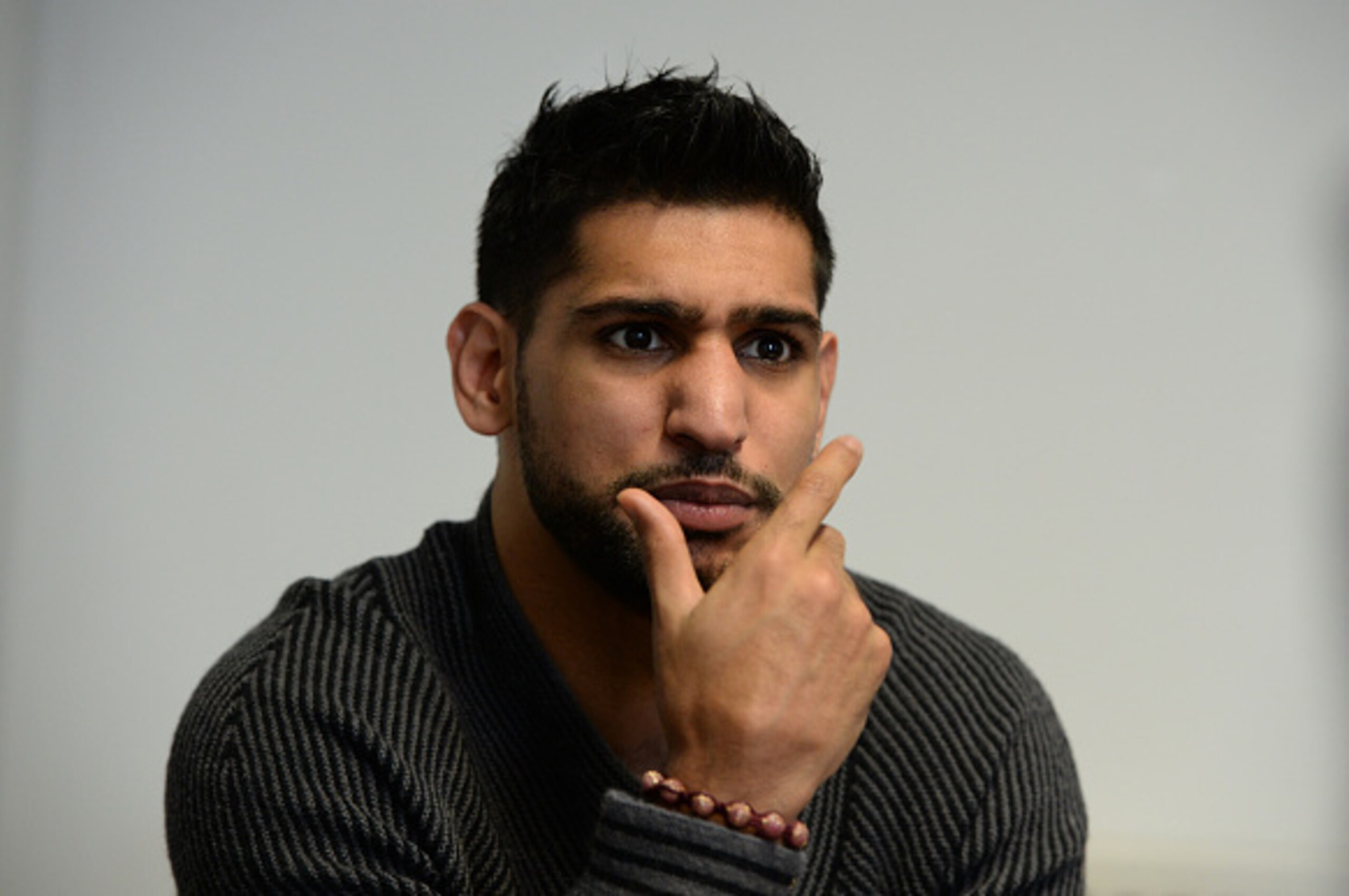SHEFFIELD, ENGLAND - FEBRUARY 19:  Boxer Amir Khan speaks to media during a visit to Fight Label who make his shorts on February 19, 2015 in Sheffield, England.  (Photo by Nigel Roddis/Getty Images)
