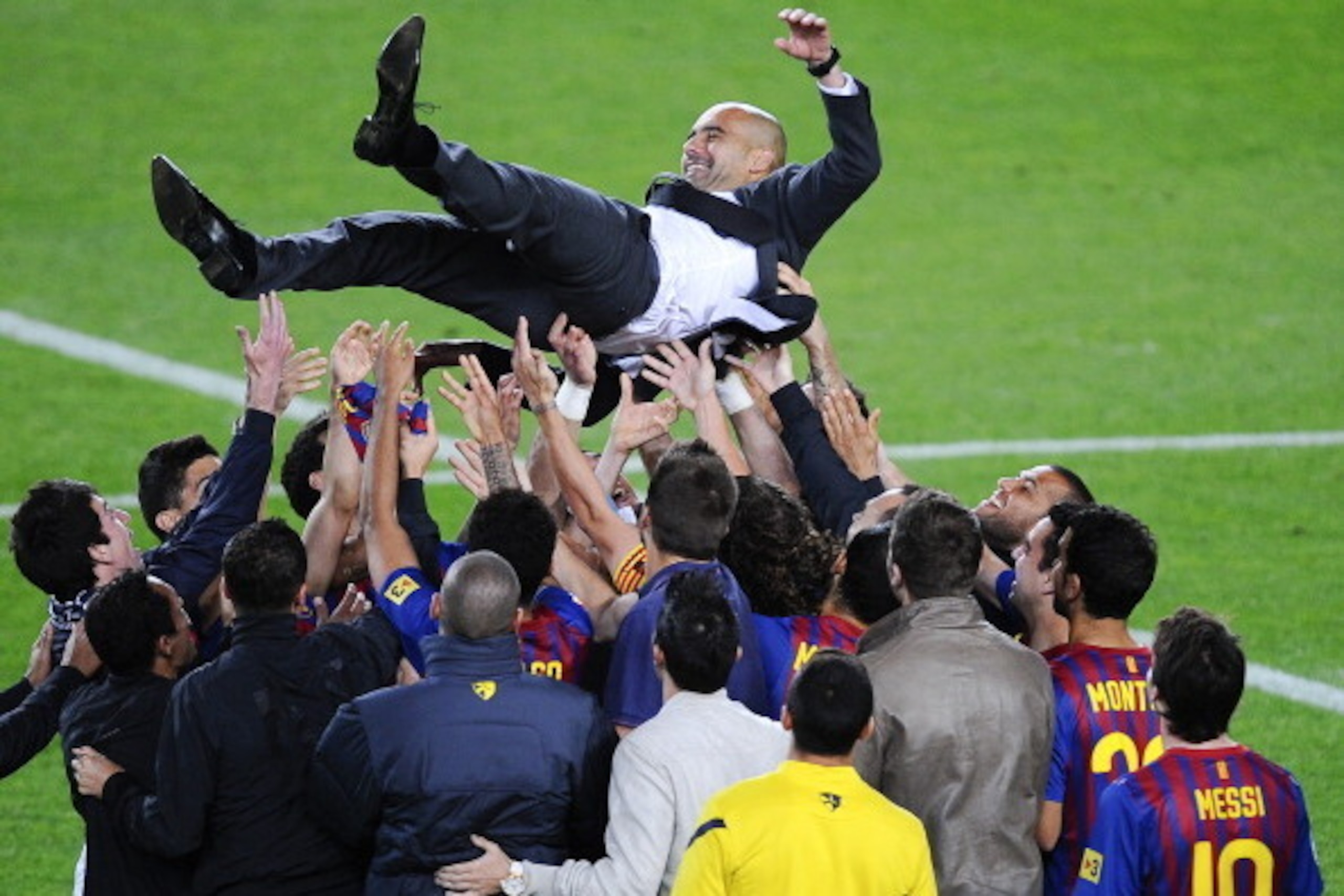 BARCELONA, SPAIN - MAY 05:  FC Barcelona players throw Josep Guardiola their head coach into the air at the end of the La Liga match between FC Barcelona and RCD Espanyol at Camp Nou on May 5, 2012 in Barcelona, Spain. This was Guardiola's last match. .  