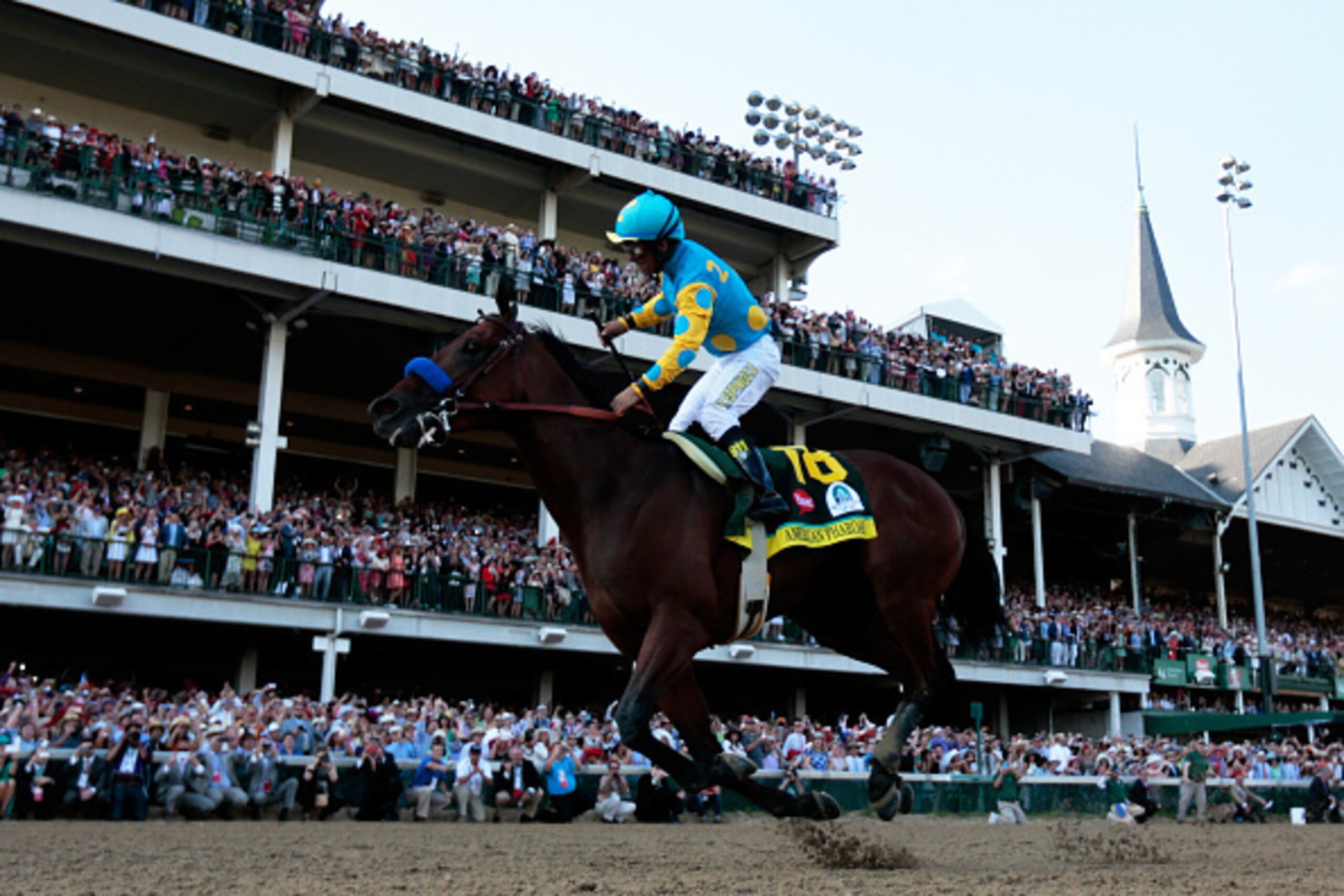 LOUISVILLE, KY - MAY 02:  Jockey Victor Espinoza celebrates as he guides American Pharoah #18 after crossing the finish line to win the 141st running of the Kentucky Derby at Churchill Downs on May 2, 2015 in Louisville, Kentucky.  (Photo by Rob Carr/Gett