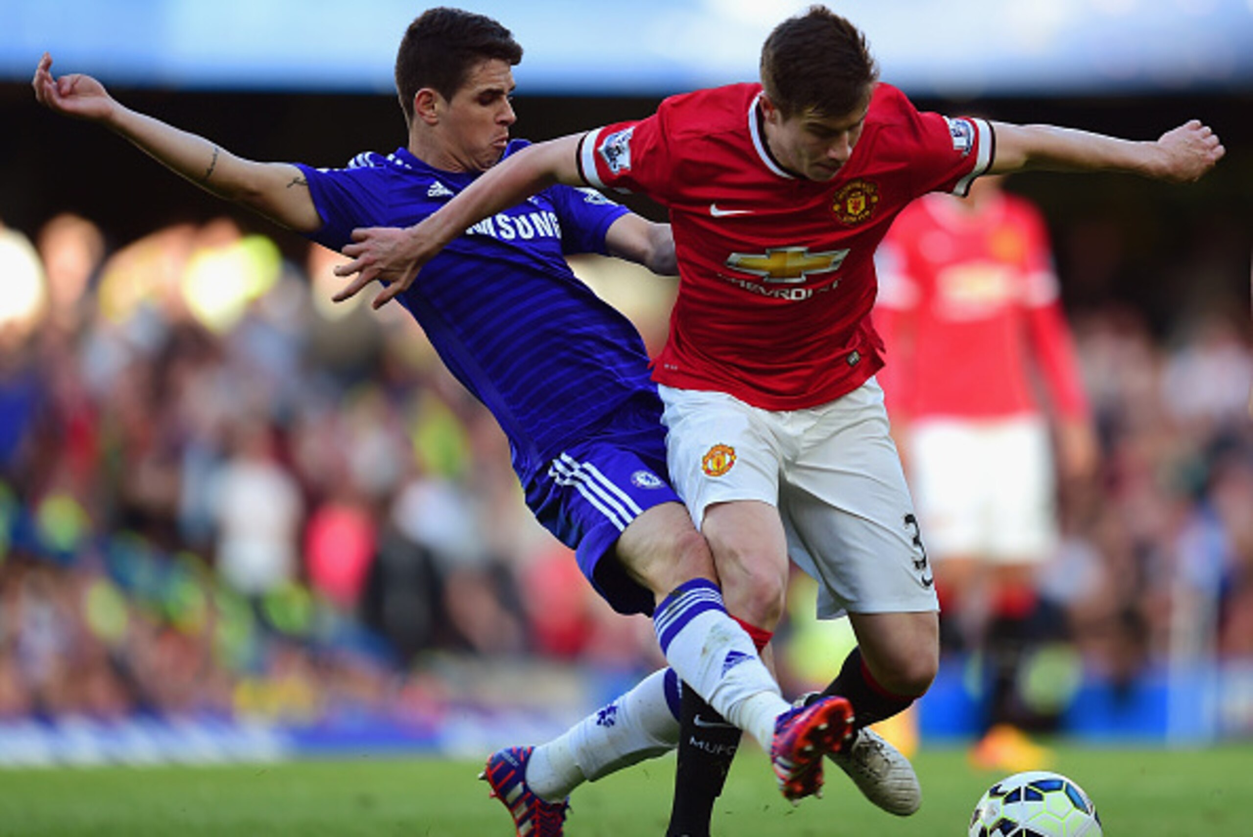 LONDON, ENGLAND - APRIL 18:  Oscar of Chelsea tackles Paddy McNair of Manchester United  during the Barclays Premier League match between Chelsea and Manchester United at Stamford Bridge on April 18, 2015 in London, England.  (Photo by Jamie McDonald/Gett