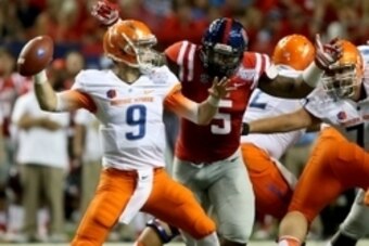 Aug 28, 2014; Atlanta, GA, USA; Boise State Broncos quarterback Grant Hedrick (9) throws a pass as Mississippi Rebels defensive tackle Robert Nkemdiche (5) pressures him in the first quarter of the 2014 Chick-fil-A Kickoff Game at the Georgia Dome. Mandat