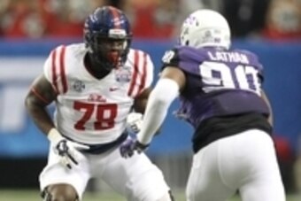 Dec 31, 2014; Atlanta , GA, USA; Mississippi Rebels offensive lineman Laremy Tunsil (78) prepares to block TCU Horned Frogs defensive tackle Terrell Lathan (90) during the first quarter in the 2014 Peach Bowl at the Georgia Dome. Mandatory Credit: Brett D