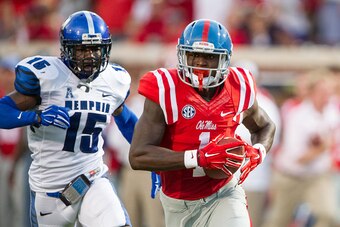 OXFORD, MS - SEPTEMBER 27:  Wide receiver Laquon Treadwell #1 of the Mississippi Rebels runs the ball downfield after catching a pass in front of defensive back Fritz Etienne #15 of the Memphis Tigers on September 27, 2014 at Vaught-Hemingway Stadium in O