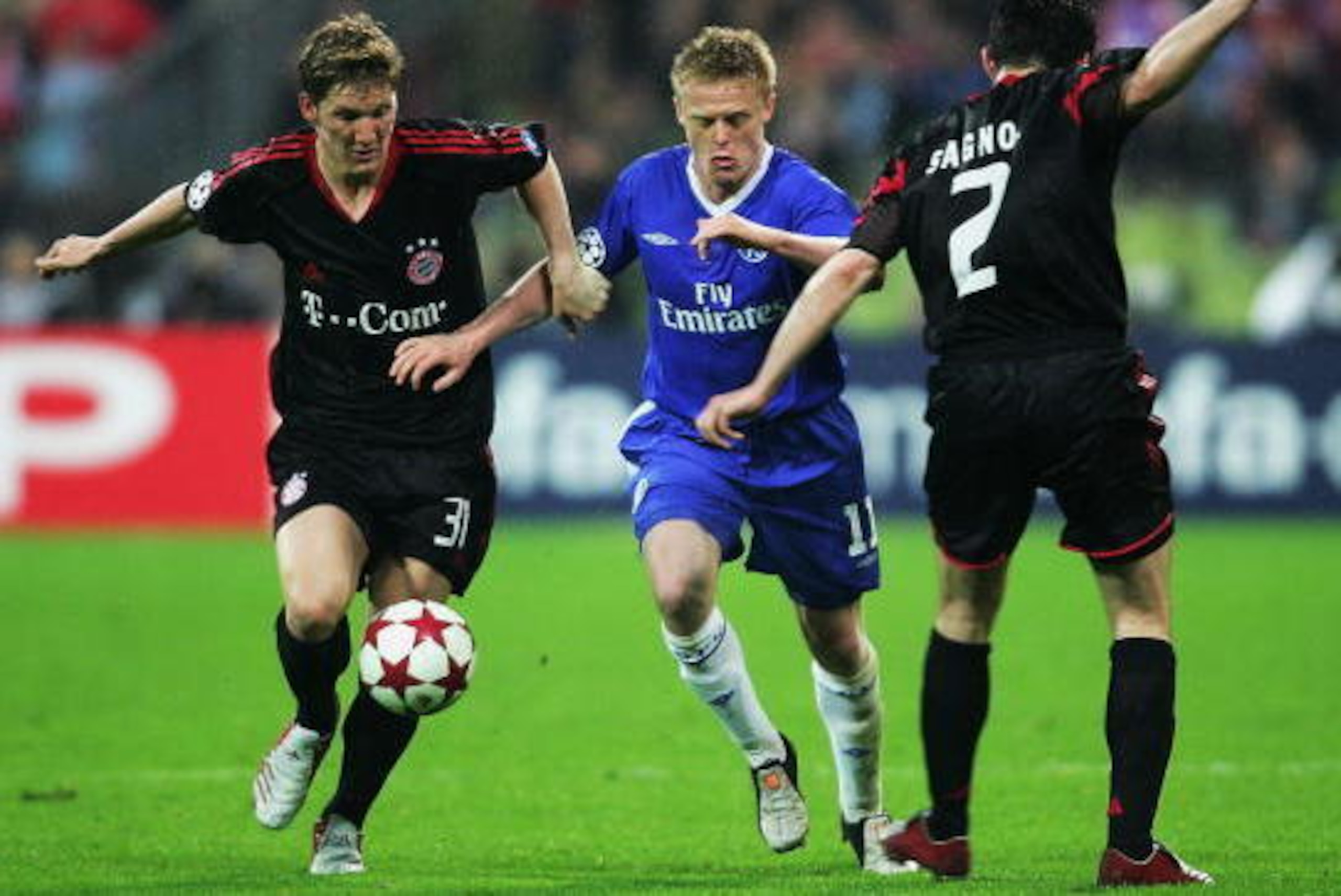 MUNICH, GERMANY - APRIL 12: Bastian Schweinsteiger (L) and Willy Sagnol (R) of Bayern Munich challenge for the ball with Damien Duff of Chelsea during the UEFA Champions League quarter final second leg match between Bayern Munich and Chelsea at the Olympi