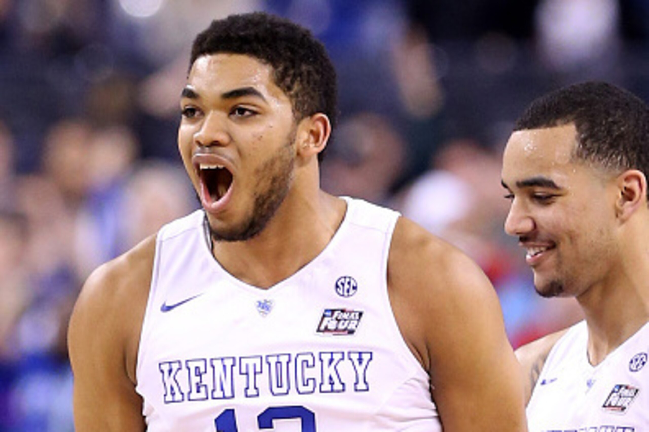 INDIANAPOLIS, IN - APRIL 04:  Karl-Anthony Towns #12 of the Kentucky Wildcats reacts after a play in the second half against the Wisconsin Badgers during the NCAA Men's Final Four Semifinal at Lucas Oil Stadium on April 4, 2015 in Indianapolis, Indiana.  