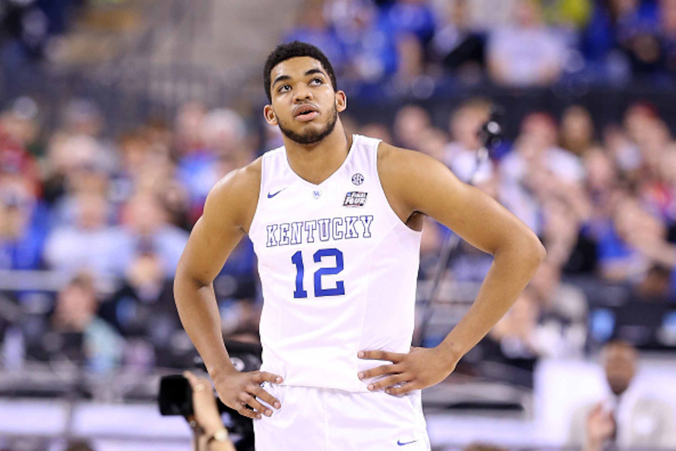 INDIANAPOLIS, IN - APRIL 04: Karl-Anthony Towns #12 of the Kentucky Wildcats looks on in the second half against the Wisconsin Badgers during the NCAA Men's Final Four Semifinal at Lucas Oil Stadium on April 4, 2015 in Indianapolis, Indiana.  (Photo by An