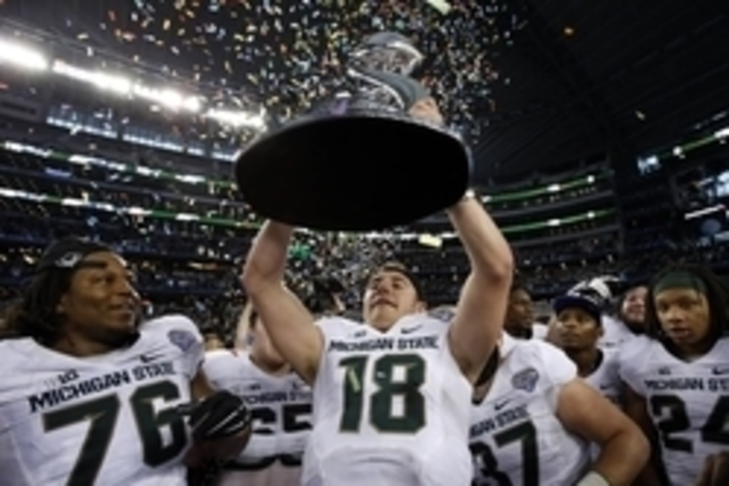 Jan 1, 2015; Arlington, TX, USA; Michigan State Spartans quarterback Connor Cook (18) holds up the Cotton Bowl trophy after the game against the Michigan State Spartans in the 2015 Cotton Bowl Classic at AT&T Stadium. Michigan State beat Baylor 42-41. Man