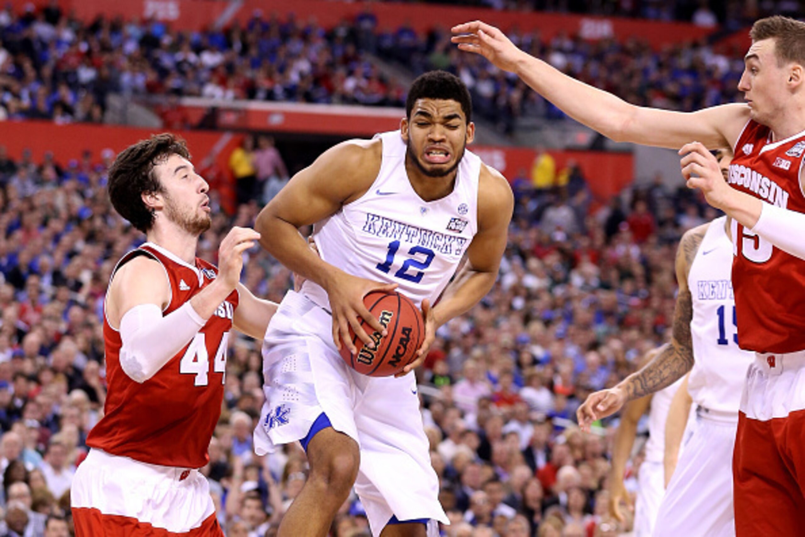 INDIANAPOLIS, IN - APRIL 04: Karl-Anthony Towns #12 of the Kentucky Wildcats handles the ball against Frank Kaminsky #44 of the Wisconsin Badgers in the second half during the NCAA Men's Final Four Semifinal at Lucas Oil Stadium on April 4, 2015 in Indian
