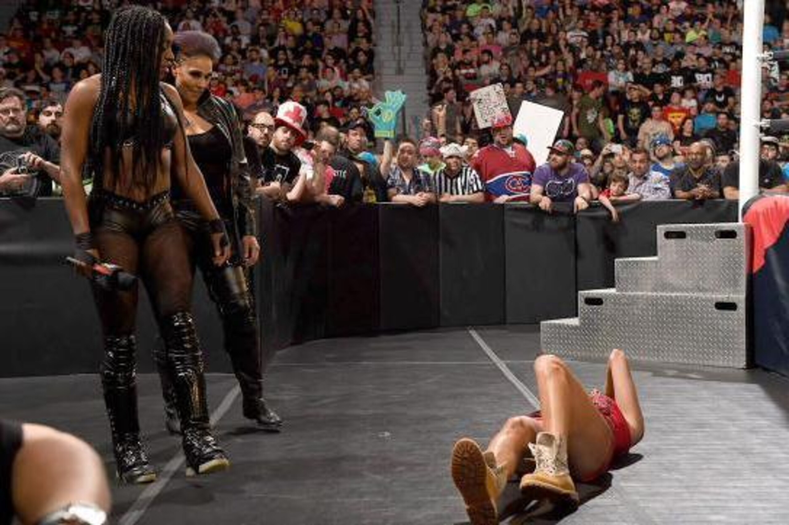 Naomi and Tamina Snuka eye a fallen Brie Bella.