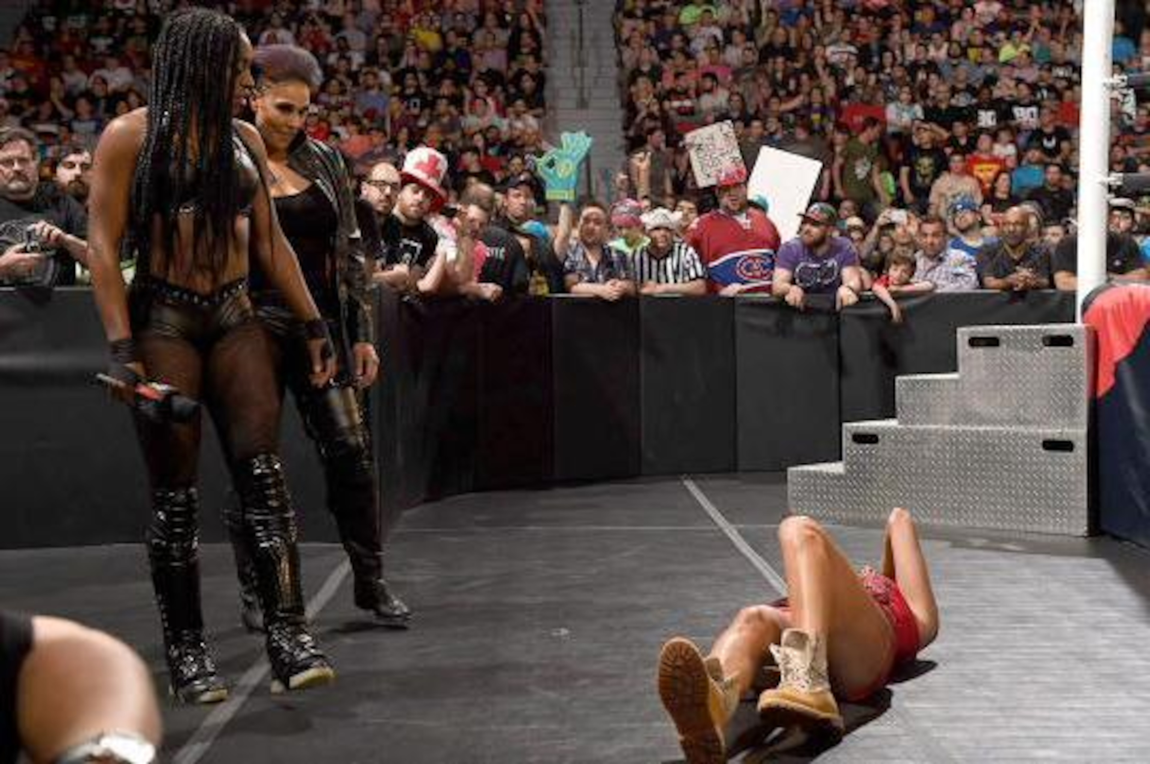Naomi and Tamina Snuka eye a fallen Brie Bella.